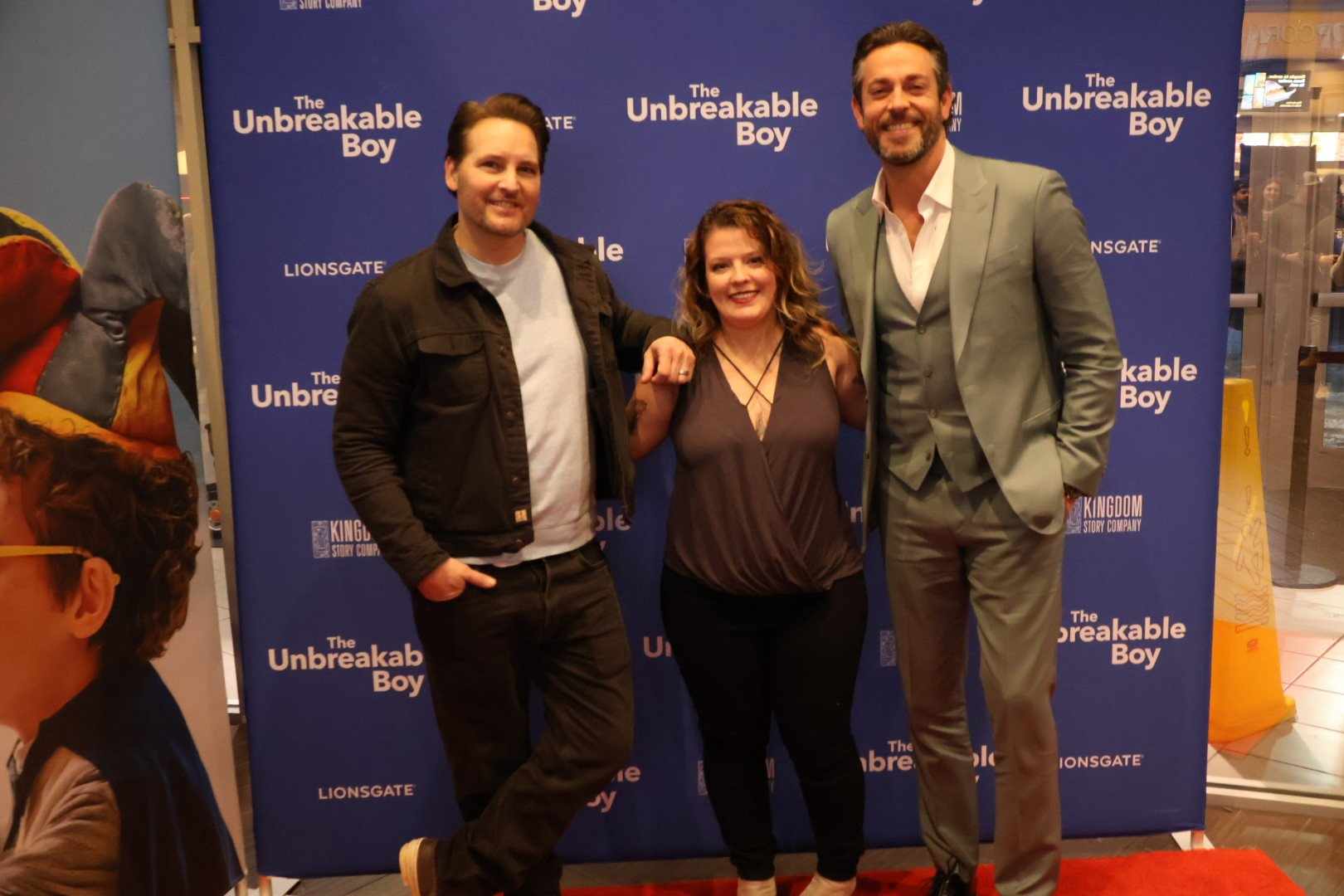 Peter Facinelli and Zachary Levi pose with Brittany Gardner at the red carpet premiere of “The Unbreakable Boy” at Marcus Theaters’ Twin Creek Cinema in Bellevue. Gardner, from Council Bluffs, works with special needs students.<br />(Tim Trudell / The Daily Record)