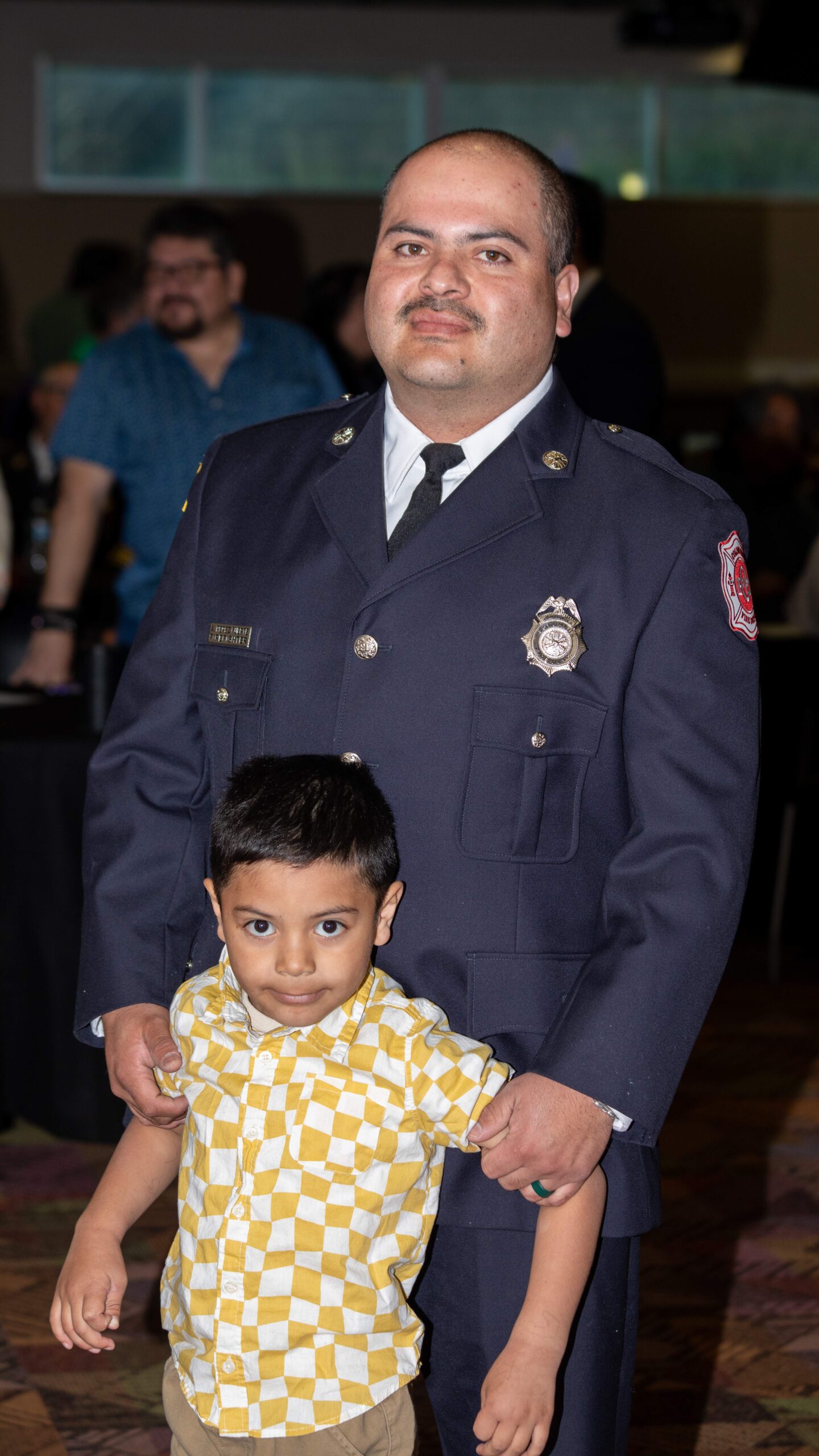 Firefighter Aaron Perez and one of his children.<br />(Courtesy of Eli Rigatuso, Bellevue University)