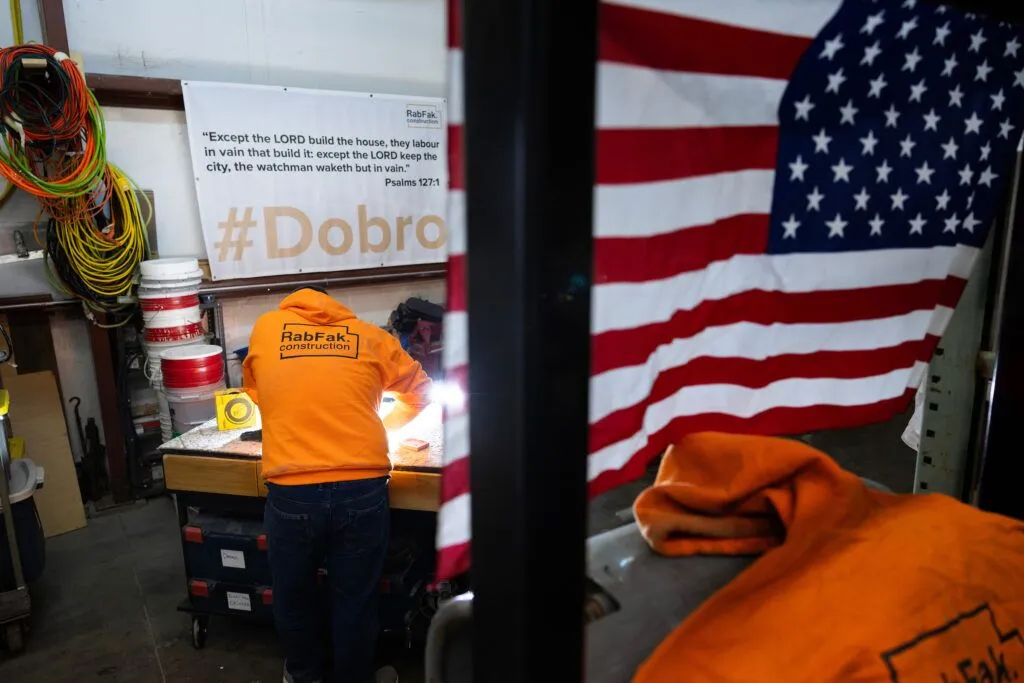 Freddy Hafiz sands a cabinet door in the shop at RabFak Construction on Friday, Jan. 17, 2025, in Omaha.<br />(Rebecca S. Gratz / Flatwater Free Press)