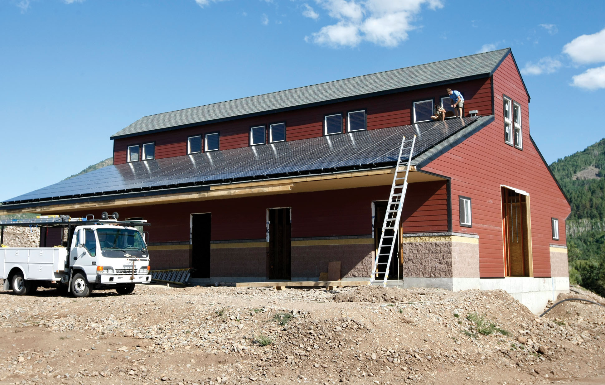Dusty Bender and Allen Riling, both with Shaw Solar and Energy Conservation, install two of 105 solar panels on the roof of a barn Thursday, Aug. 27, 2009, north of Hesperus, Colo.<br />(Jerry McBride / AP Photo)