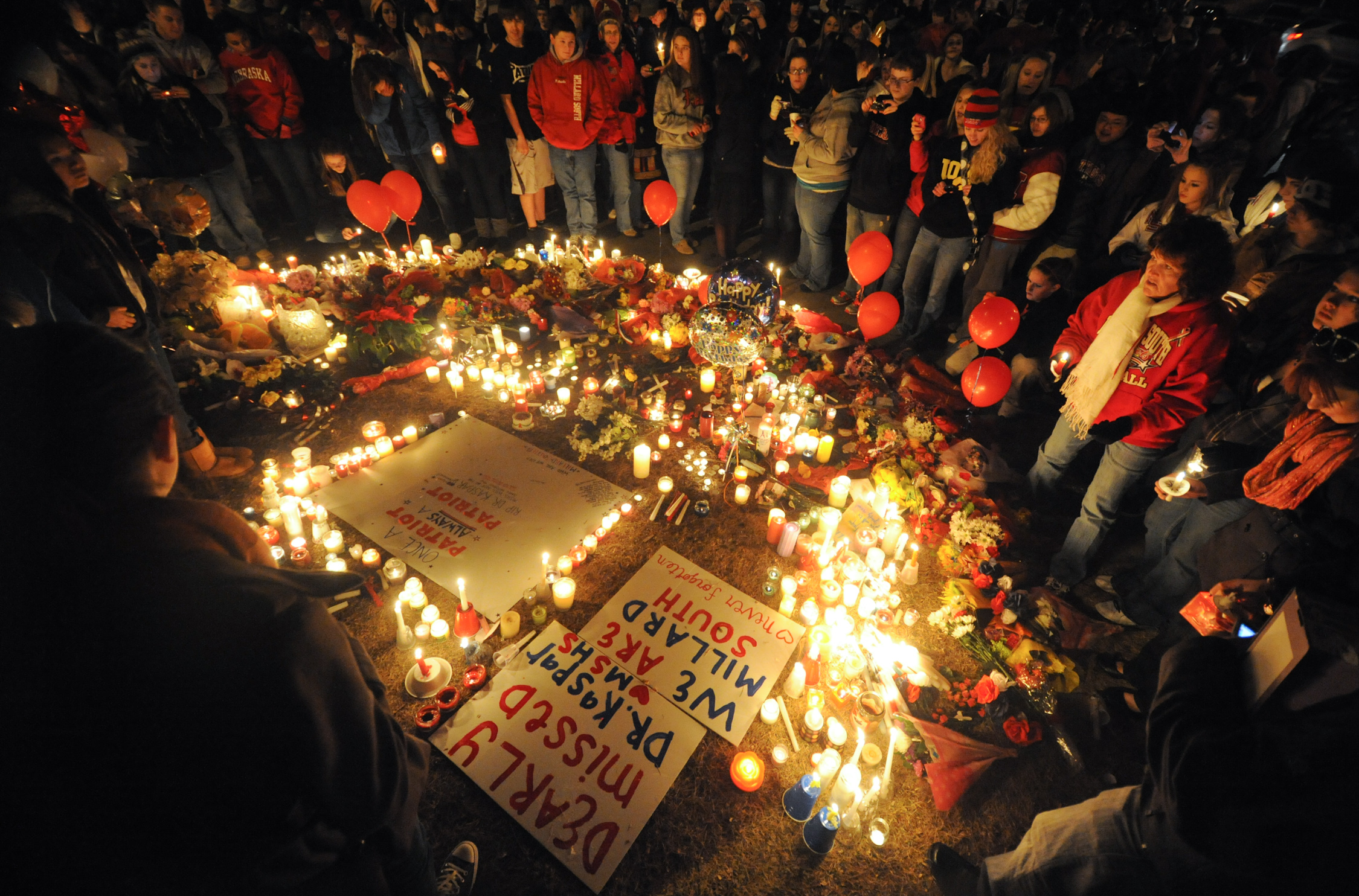 Millard South High School students hold a candle light vigil in front of the school in Omaha, Neb after a mass shooting on Thursday Jan 6, 2011. Ryan Busse once worked for a major gun-maker. He now warns about the danger of growing radicalization in the industry.  (Dave Weaver / AP Photo)