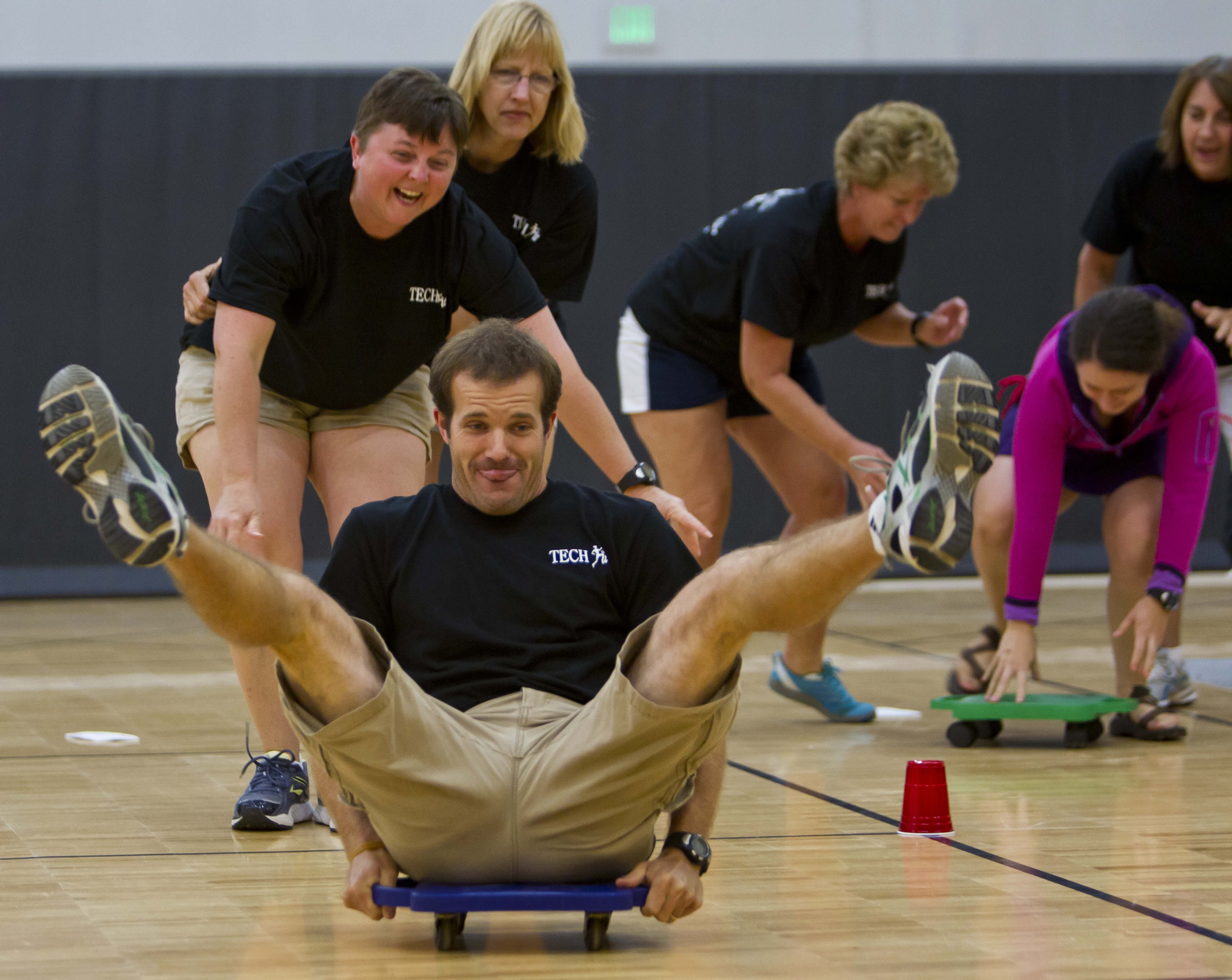 Teachers Sabrina Wickens (left) and Cheryl Girman watch Matt Moyer after they pushed him off during a game at the Teaching Engineering Concepts to Harness Future Innovators and Technologists teachers workshop Friday, July 18, 2014, at Purdue University in West Lafayette, Ind. The 10-week after school program has the teachers use technology to create fitness games.<br />(Michael Heinz / Journal &amp; Courier via AP)