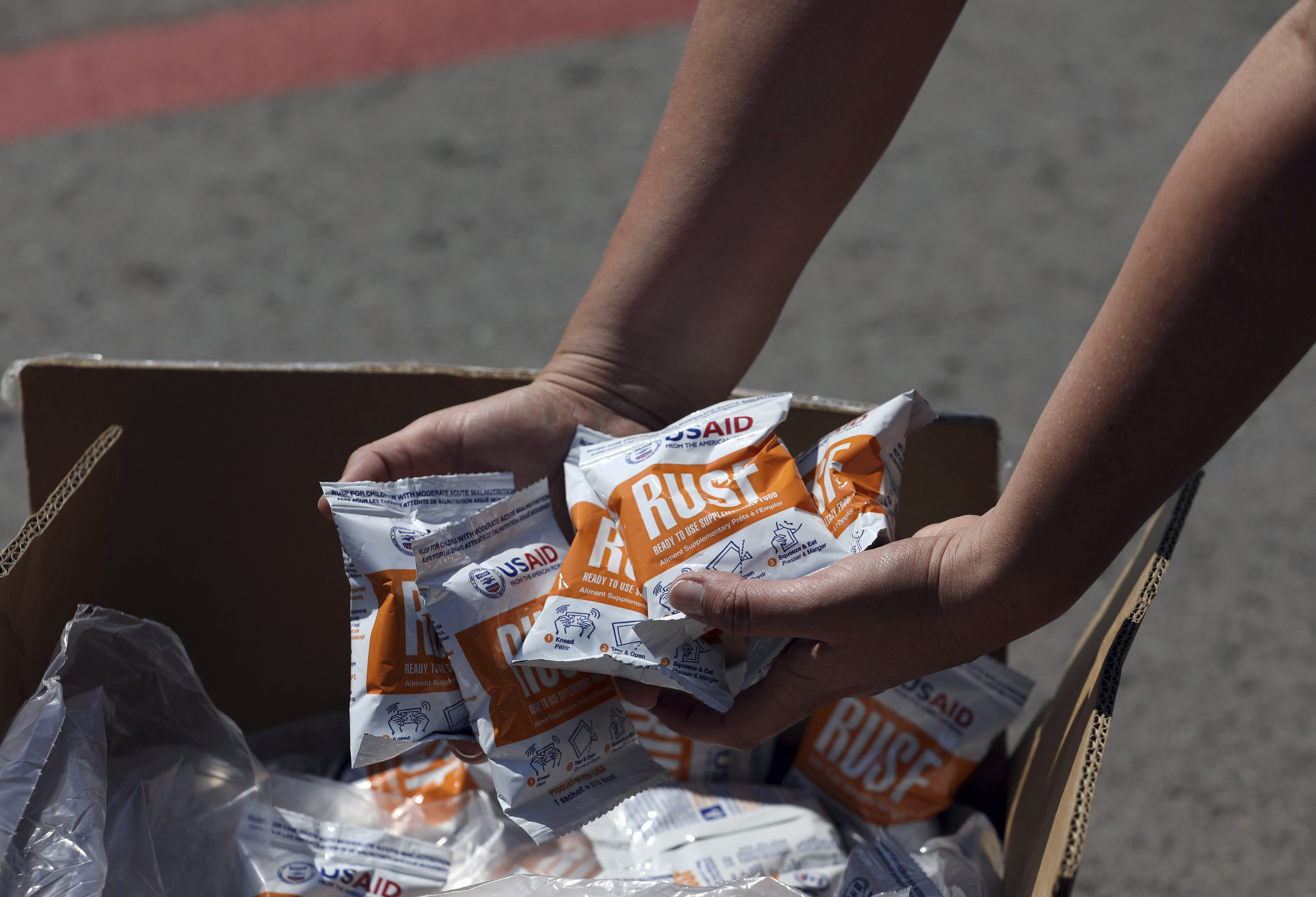 Packets of USAID Ready To Use Supplementary Food, RUST, are displayed by an envoy of Venezuela&#039;s self-proclaimed interim president Juan Guaido, as part of the Humanitarian aid flown in on United States Air Force C-17 cargo planes, at Camilo Daza airport in Cucuta, Colombia, Saturday, Feb. 16, 2019.<br />(Fernando Vergara / AP Photo)