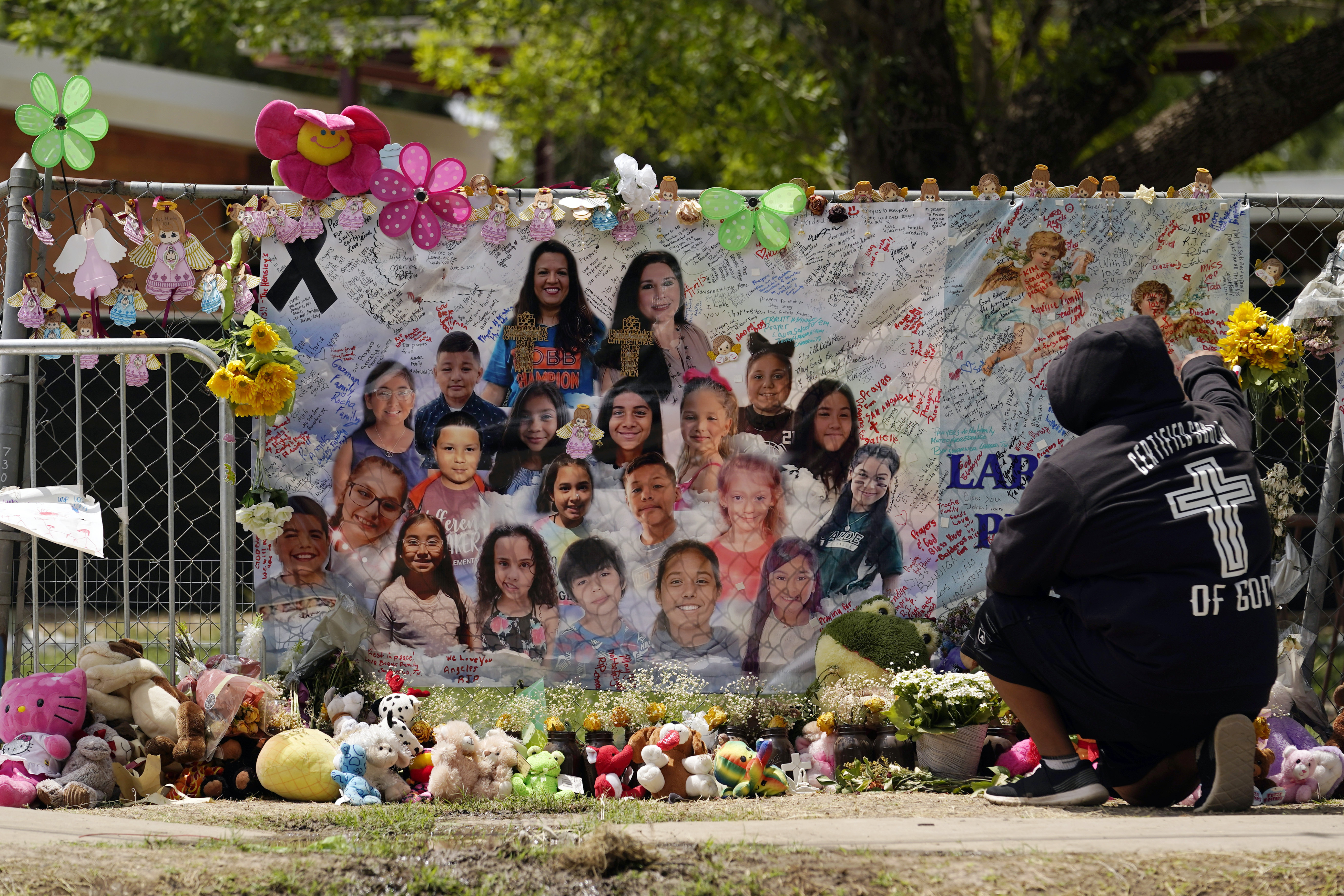 A mourner stops to pay his respects at a memorial at Robb Elementary School, created to honor the victims killed in the recent school shooting, June 9, 2022, in Uvalde, Texas. Two teachers and 19 students were killed in the mass shooting. (Eric Gay / AP Photo)