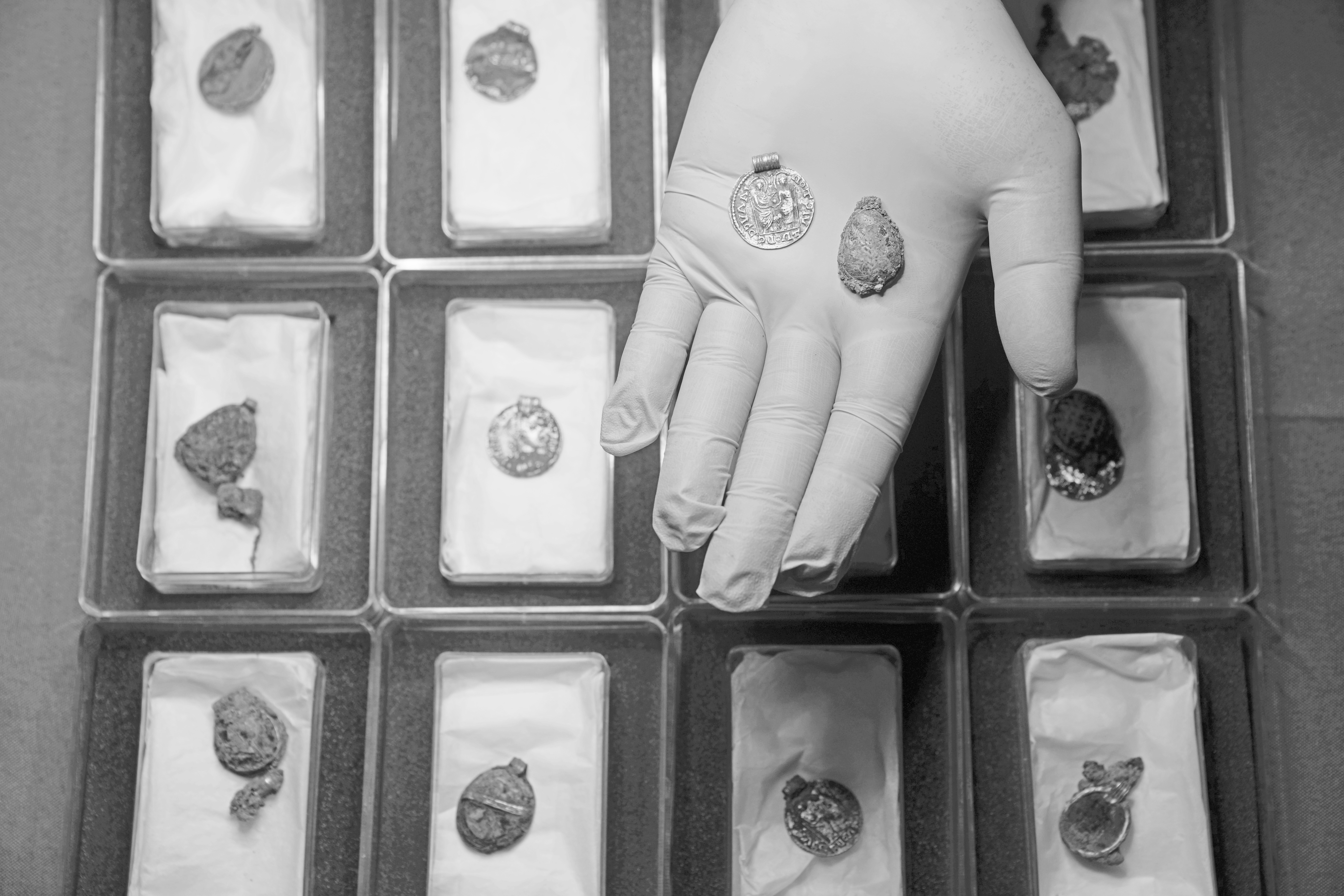 Liz Barham, senior conservator of the Museum of London Archaeology, displays an early medieval gold necklace during a photo call, in London, Tuesday, Dec. 6, 2022. (Kin Cheung / AP Photo)