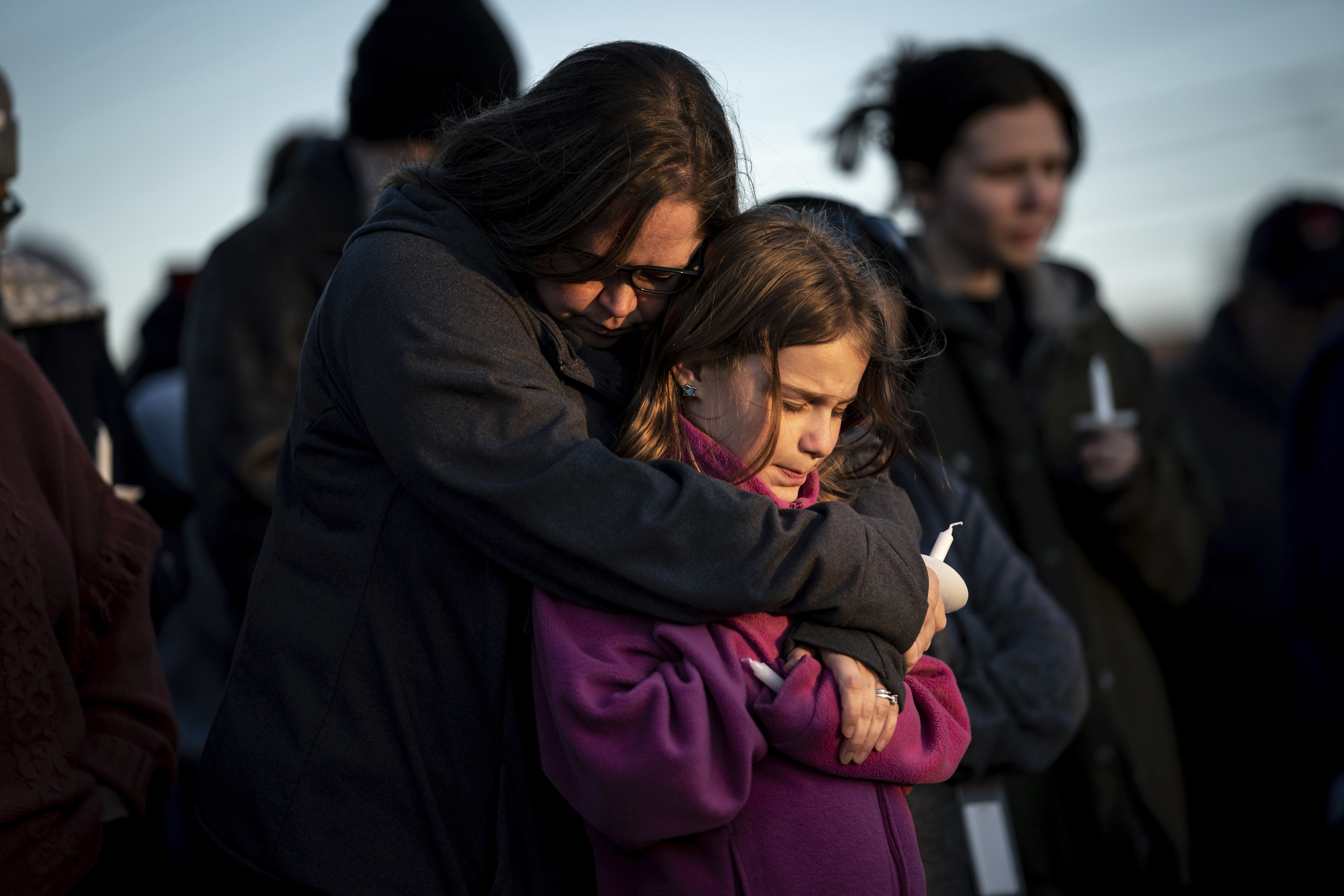 Sarah Tuck, of Lebanon, Tenn., holds her daughter Emmalin Sweeney, 10, during a community vigil on Tuesday, March 28, 2023, in Mt. Juliet, Tenn., that was held for the people killed during the Covenant School shooting. According to the Gun Violence Archive, there have been 131 mass shooting incidents in 2023 alone. 995 children were killed or injured by gun violence in 2022. (Andrew Nelles / AP Photo)