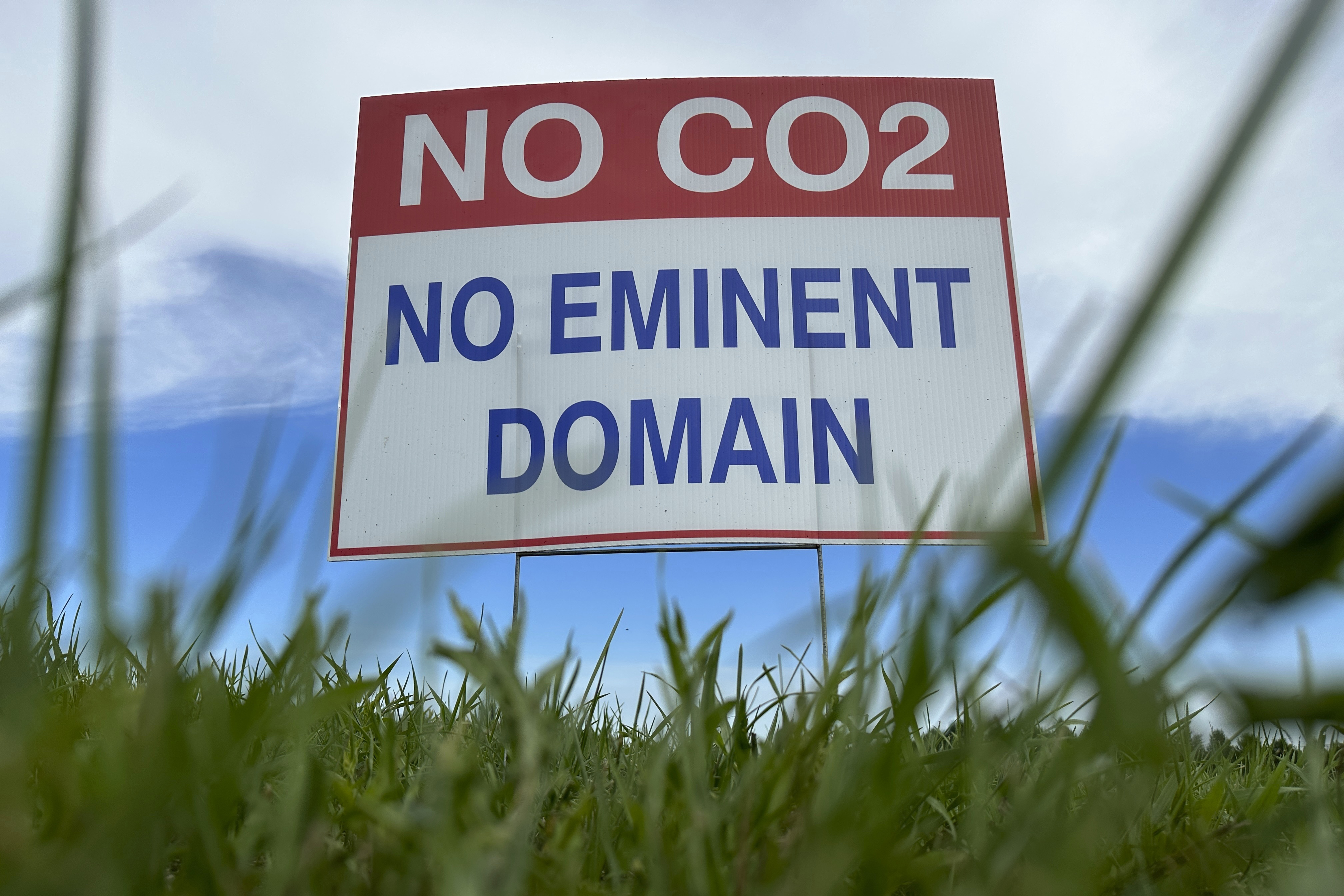 A sign reading “No CO2, no eminent domain” stands along a rural road east of Bismarck, N.D., on Aug. 15, 2023. Summit Carbon Solutions plans to build a 2,000-mile network of CO2 pipelines across the Midwest to capture carbon produced by ethanol plants and then sequester it underground in North Dakota. The Stanton County denial would require Summit Carbon Solutions to reapply for conditional use permit.<br />(Jack Dura / AP Photo)