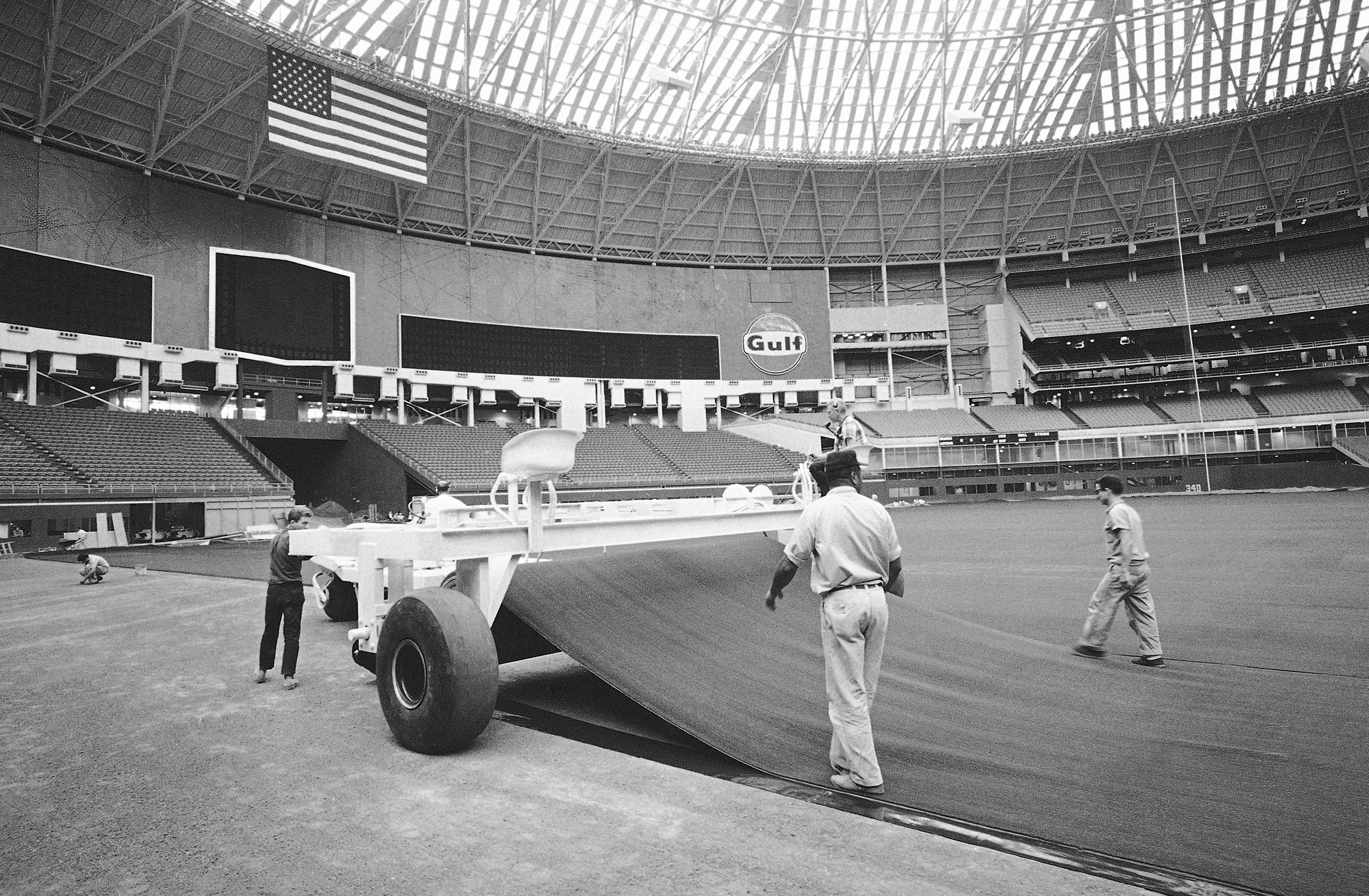 Workers lay AstroTurf at the Astrodome in Houston, July 13, 1966. Artificial turf has come a long way since it was introduced on a grand stage to the sports world at the Astrodome.<br />(Ed Kolenovsky / AP Photo)