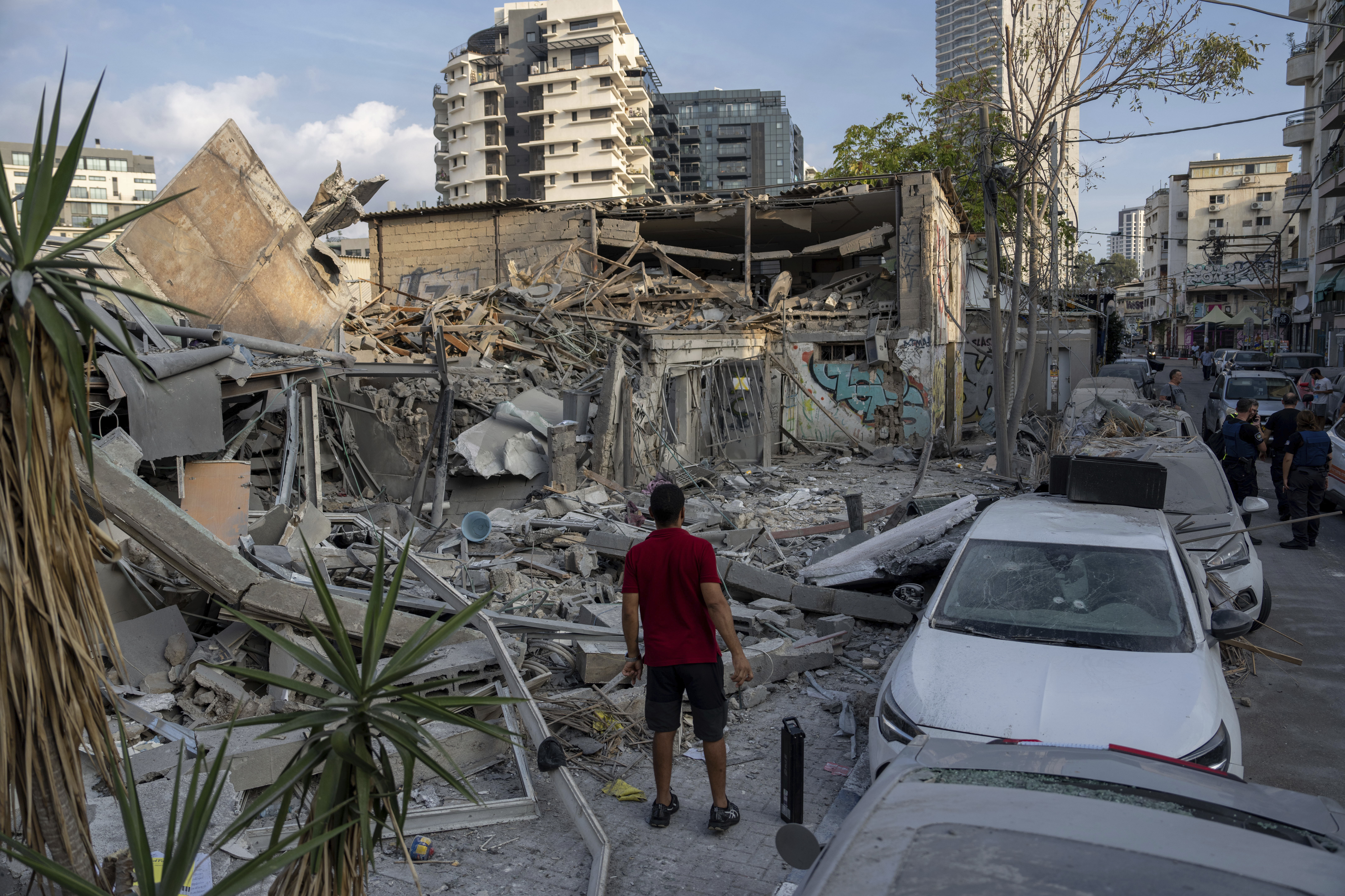 Israelis inspect the rubble of a building a day after it was hit by a rocket fired from the Gaza Strip, in Tel Aviv, Israel, Sunday, Oct. 8, 2023.<br />(Oded Balilty / AP Photo)