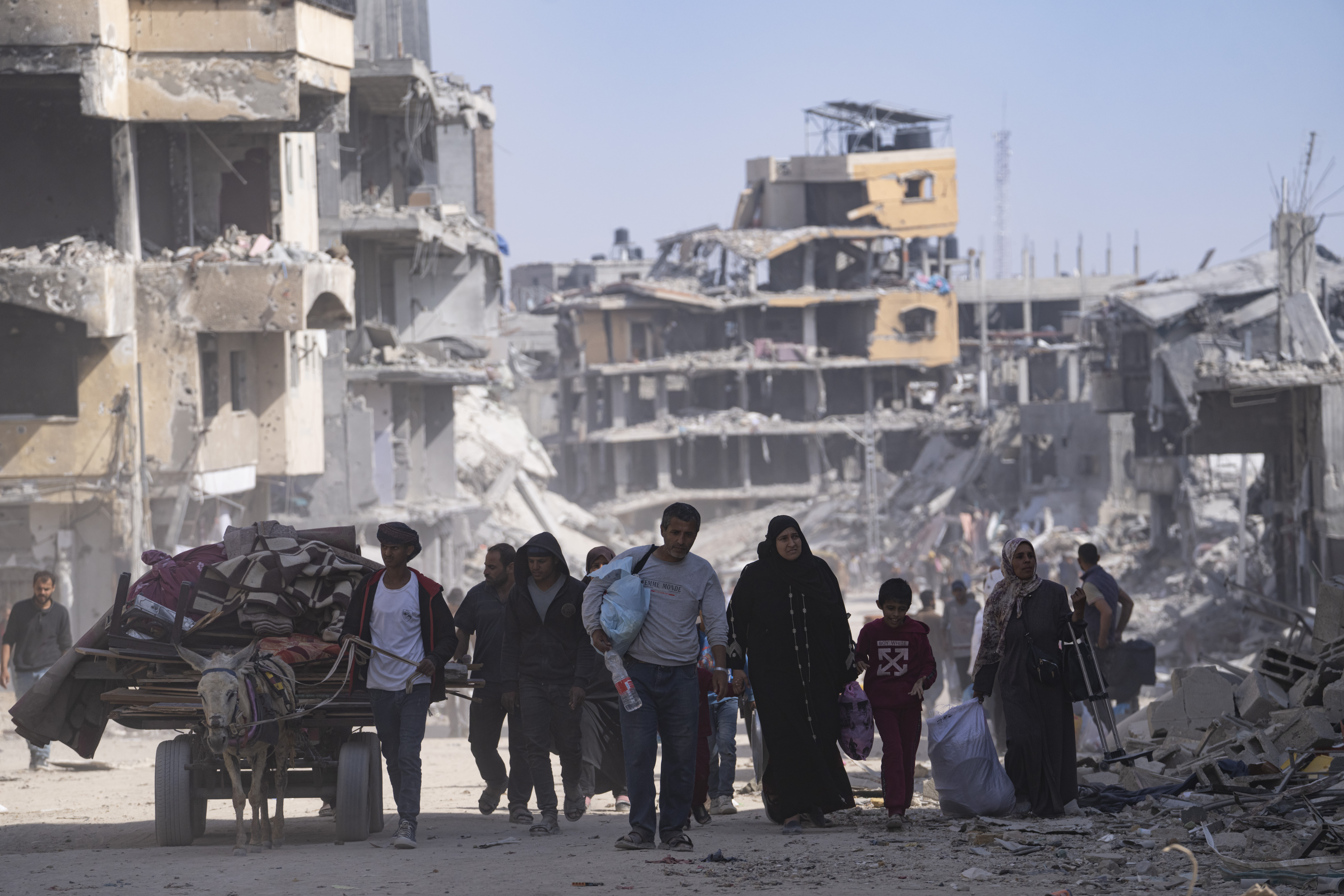 Palestinians walk through the destruction in the wake of an Israeli air and ground offensive in Khan Younis, southern Gaza Strip, Monday, April 8, 2024. Israel says it has withdrawn its last ground troops from the city, ending a four-month operation.<br />(Fatima Shbair / AP Photo)