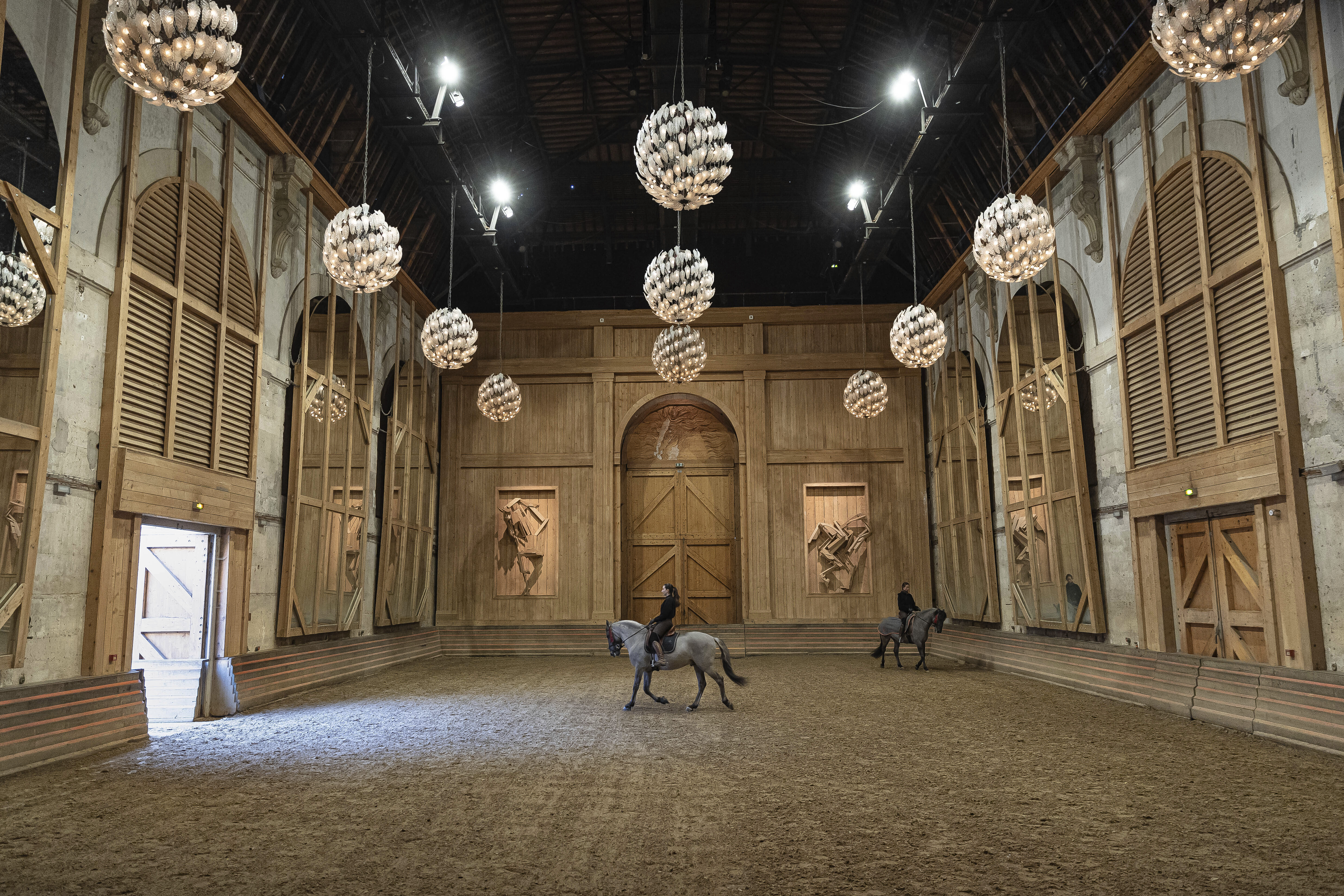 More than 340 years after the royal stables were built under the reign of France’s Sun King, riders and horses continue to train and perform in front of the Versailles Palace. The site will soon keep on with the tradition by hosting the equestrian sports during the Paris Olympics. Commissioned by King Louis XIV, the stables have been built from 1679 to 1682 opposite to the palace’s main entrance.<br />(Aurelien Morissard / AP Photo)