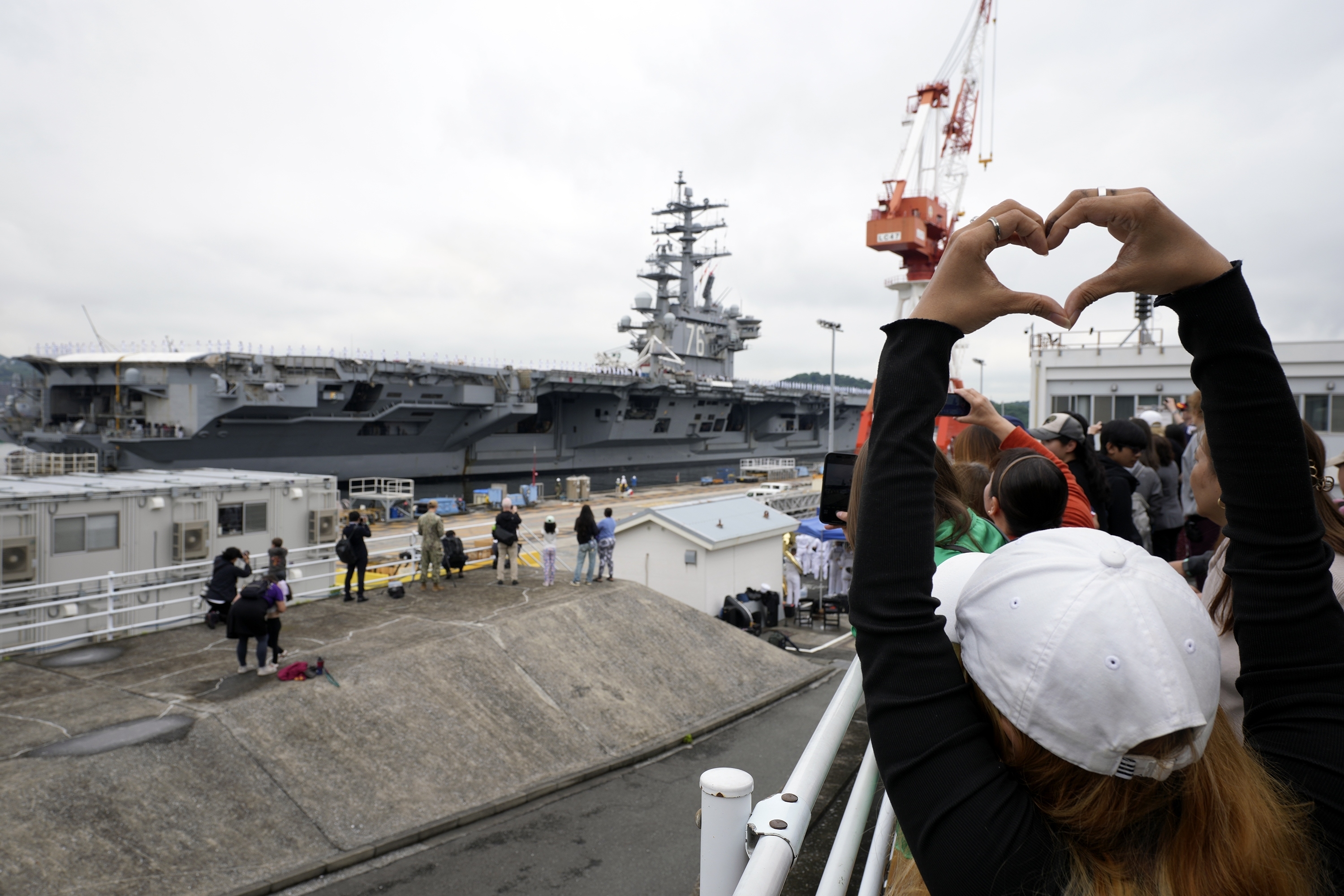 Family members and friends of the crew of the U.S. navy aircraft carriers USS Ronald Reagan (CVN-76) see off at the U.S. navy&#039;s Yokosuka base Thursday, May 16, 2024, in Yokosuka, south of Tokyo. This is the ship&#039;s final departure from Yokosuka before transiting back to the United States.<br />(Eugene Hoshiko / AP Photo)