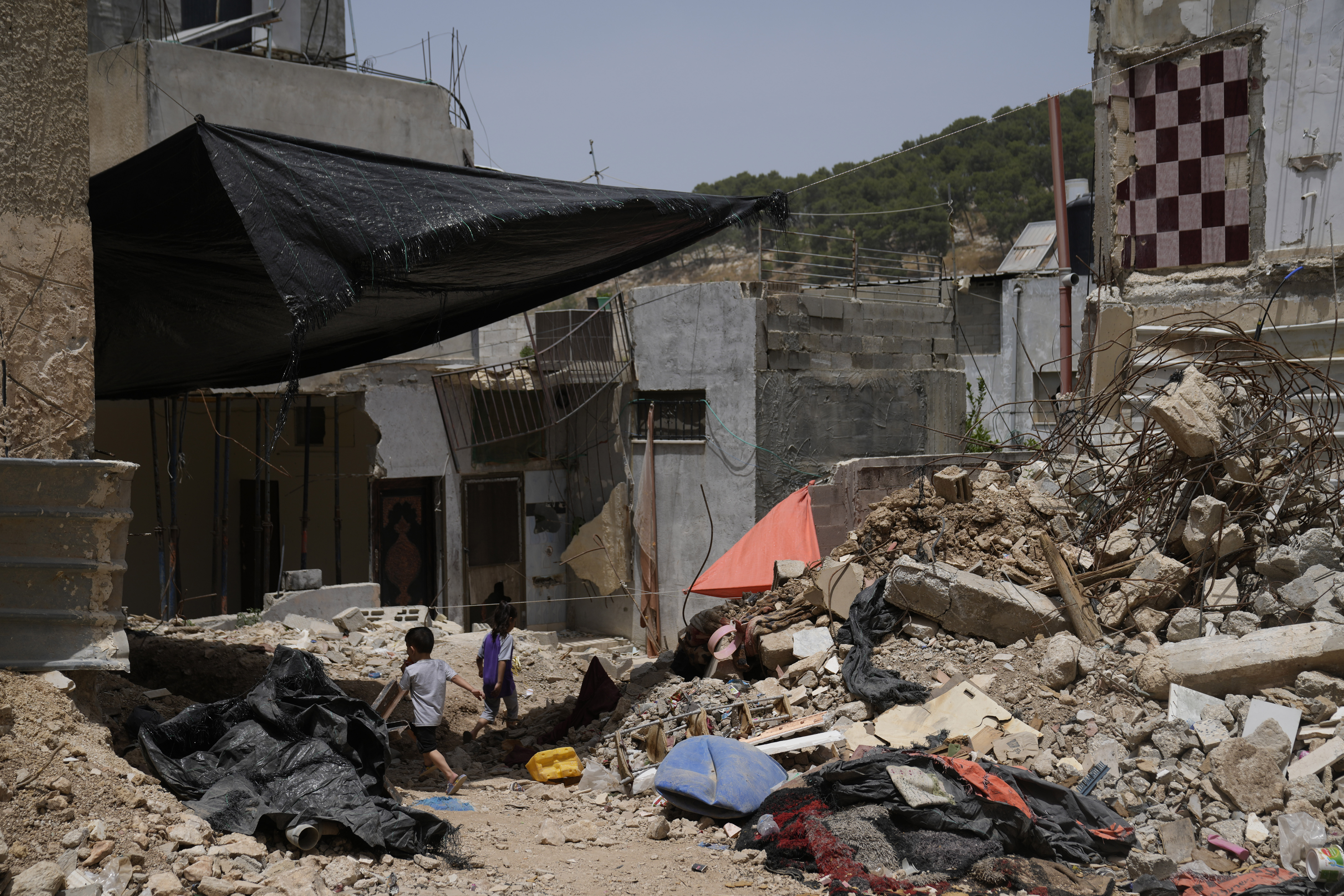 Palestinian children play by the rubble of buildings that were destroyed during Israeli army operations in the Nur Shams refugee camp in the West Bank on May 20, 2024.<br />(Nasser Nasser / AP Photo)