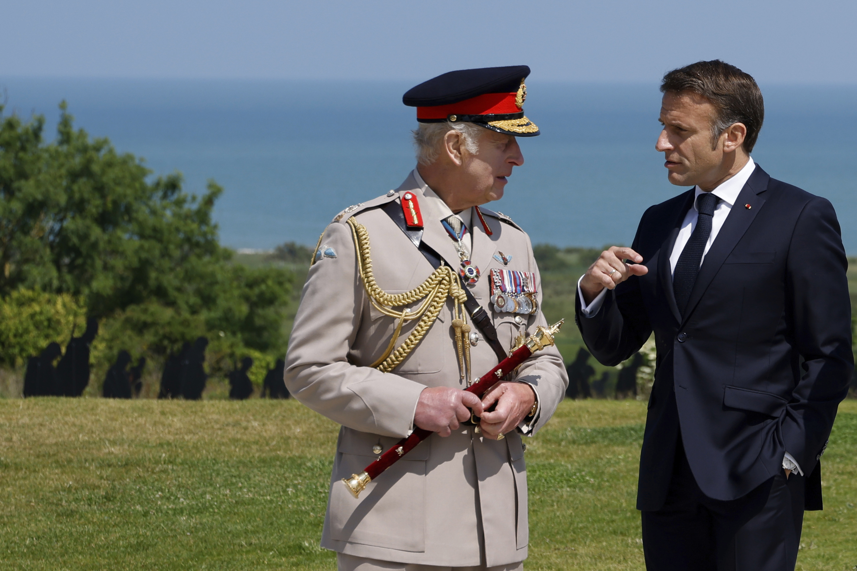 French President Emmanuel Macron, right, discusses with Britain&#039;s King Charles III during a commemorative ceremony marking the 80th anniversary of the World War II D-Day.<br />(Ludovic Marin / AP Photo)