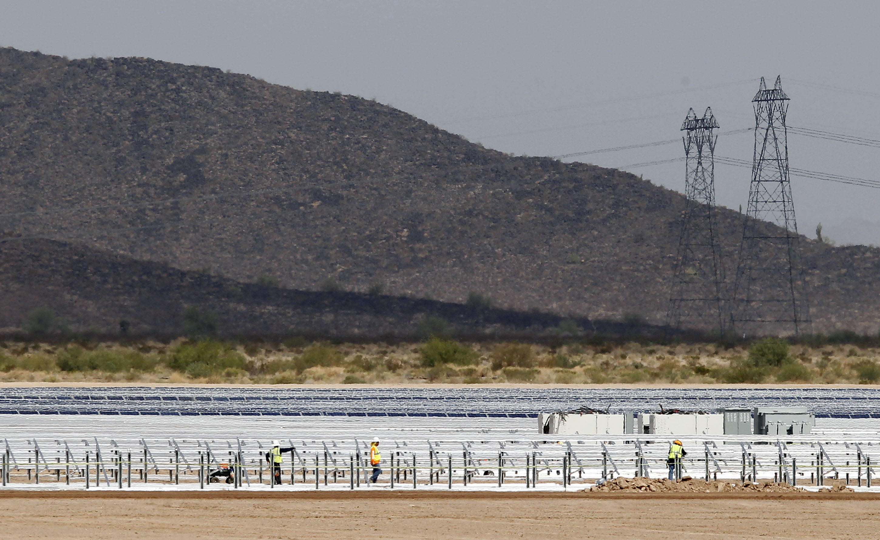 Workers continue to build rows of solar panels at a Mesquite Solar 1 facility under construction in Arlington, Ariz.<br />(Ross D. Franklin / AP Photo, File)