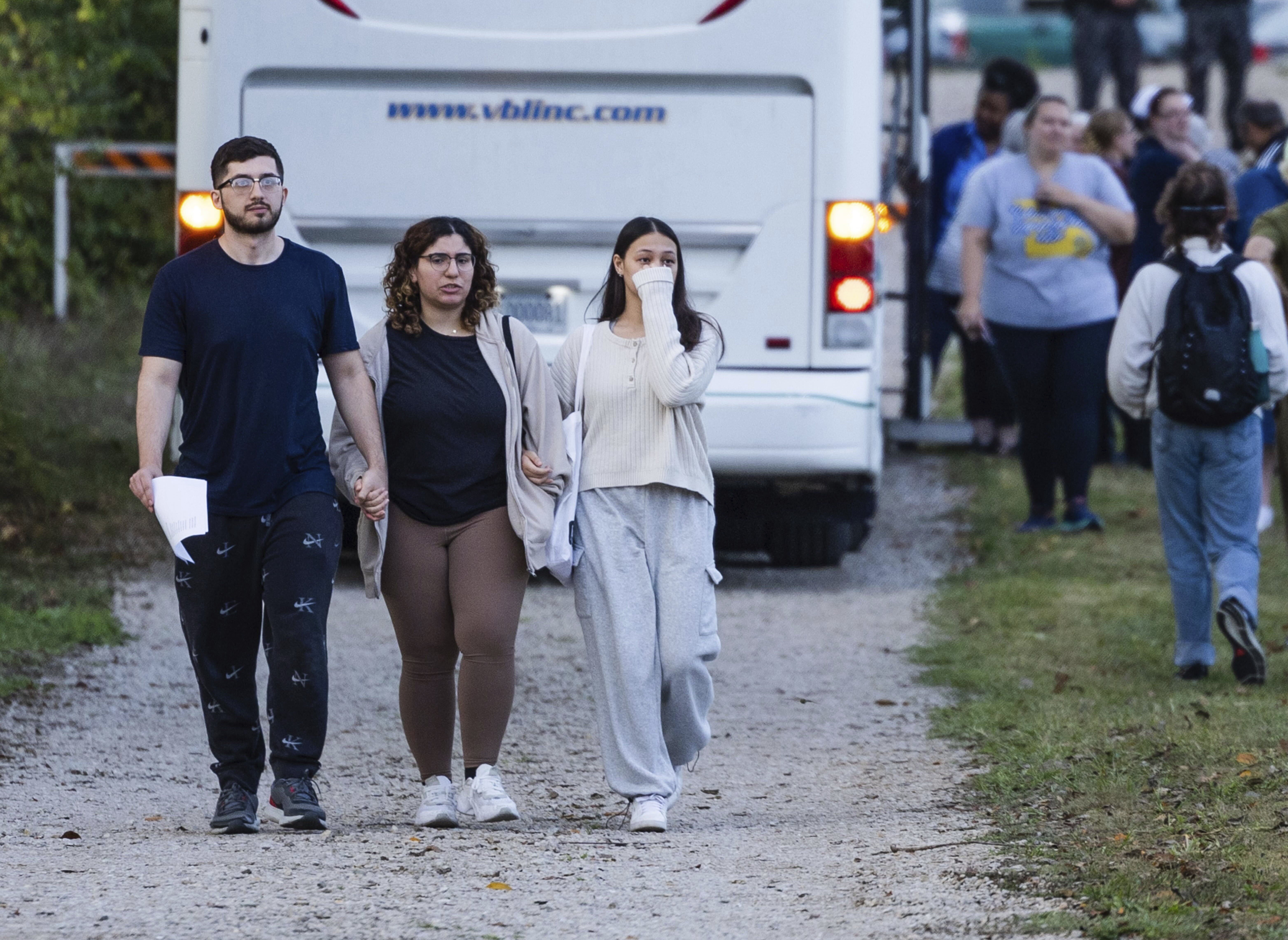 Summer Hishmeh (center) and Sakura Hassan, both from St. Louis, hold hands and cry as they walk with another man away from a protest against the execution of Marcellus Williams outside of the Missouri Department of Corrections prison, Tuesday, Sept. 24, 2024, in Bonne Terre, Mo.<br />(Zachary Linhares / St. Louis Post-Dispatch via AP)