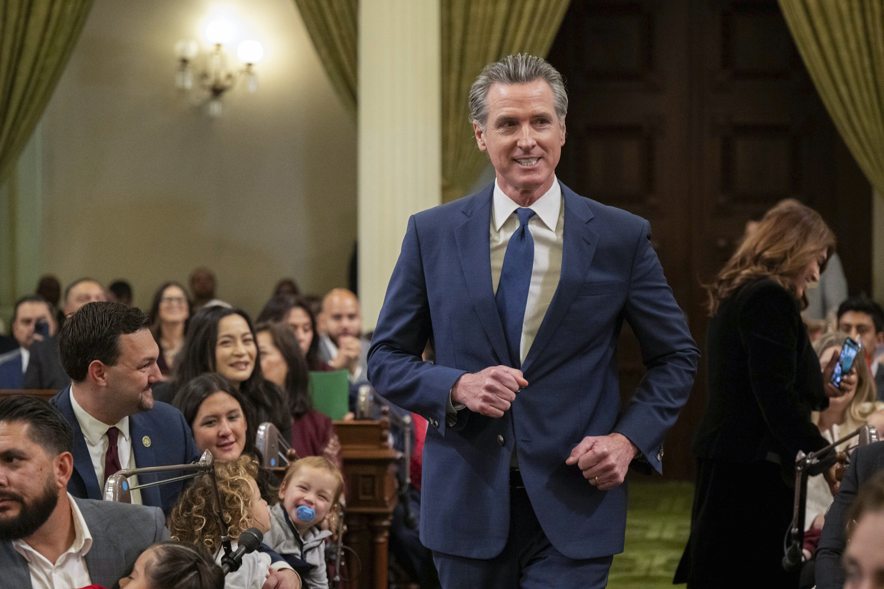 Gov. Gavin Newsom walks down the aisle at the State Capitol during the assembly&#039;s first meeting of the new legislative session on Monday, Dec. 2, 2024, in Sacramento.<br />(Paul Kitagaki Jr. / The Sacramento Bee via AP)