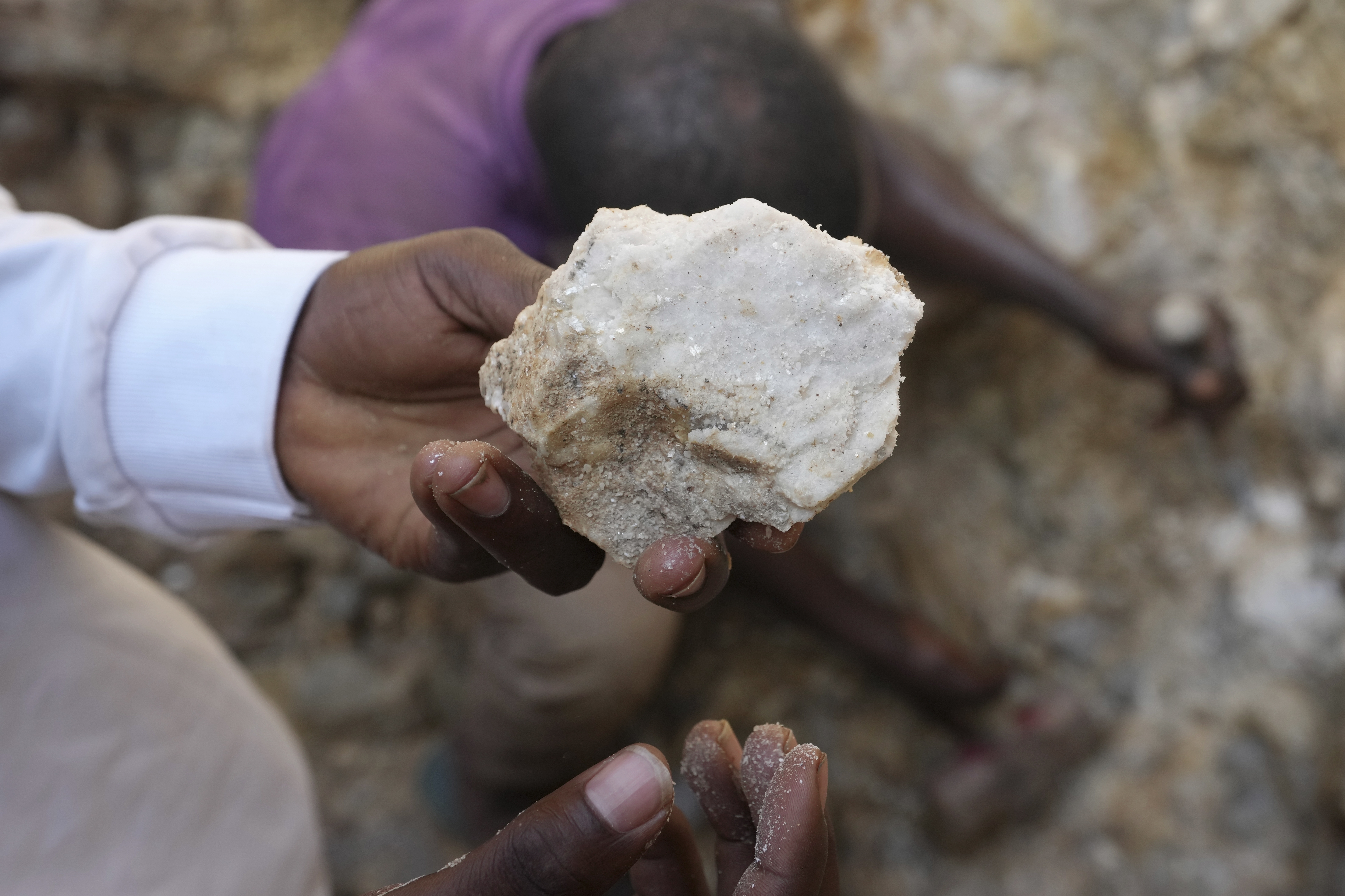A man shows lithium stone from an illegal mining site in Paseli, north central Nigeria, Tuesday, Nov 5, 2024.<br />(Sunday Alamba / AP Photo)