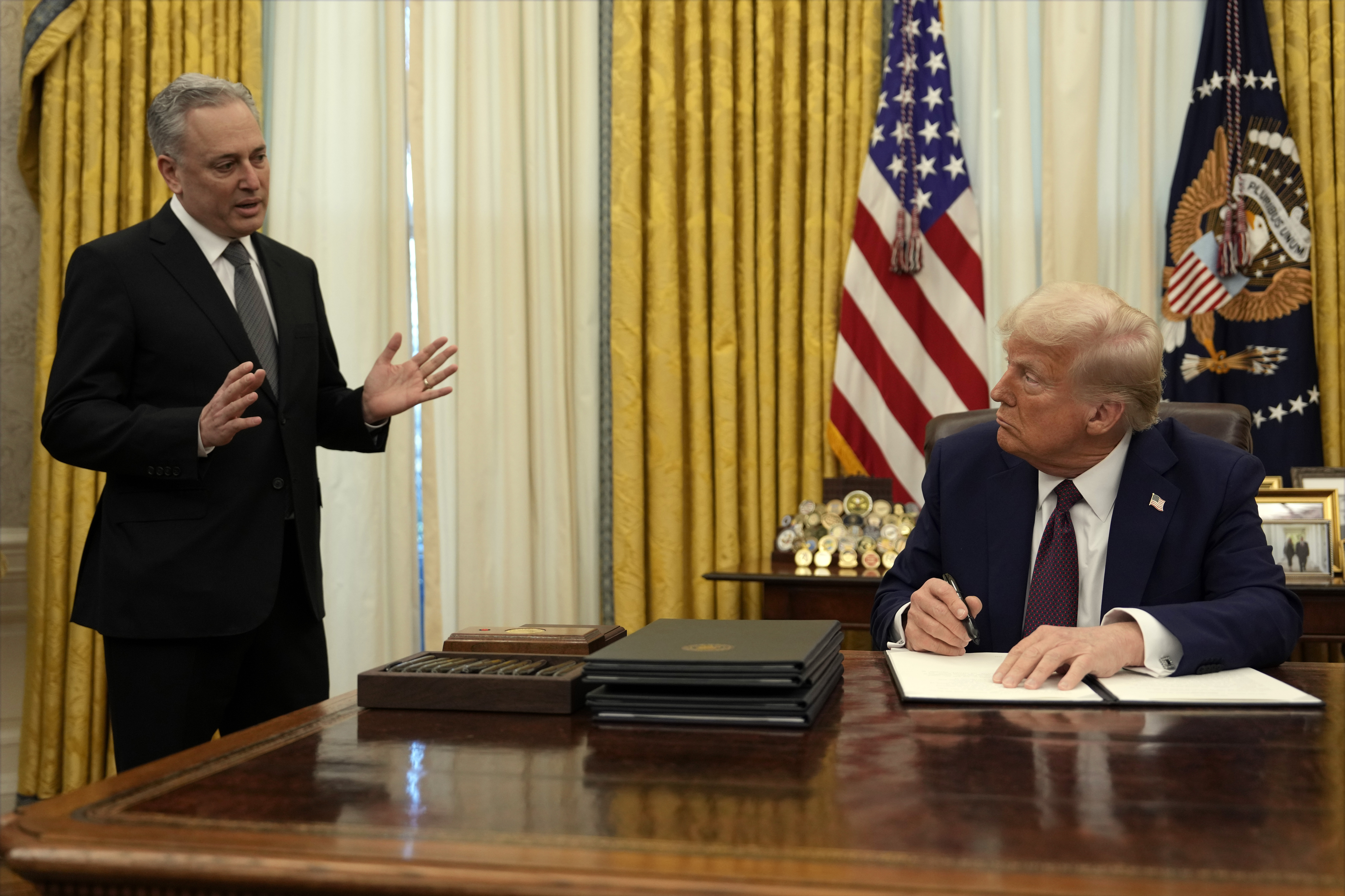President Donald Trump listens to White House adviser David Sacks as he signs an executive order regarding cryptocurrency in the Oval Office of the White House, Thursday, Jan. 23, 2025, in Washington.<br />(Ben Curtis / AP Photo)