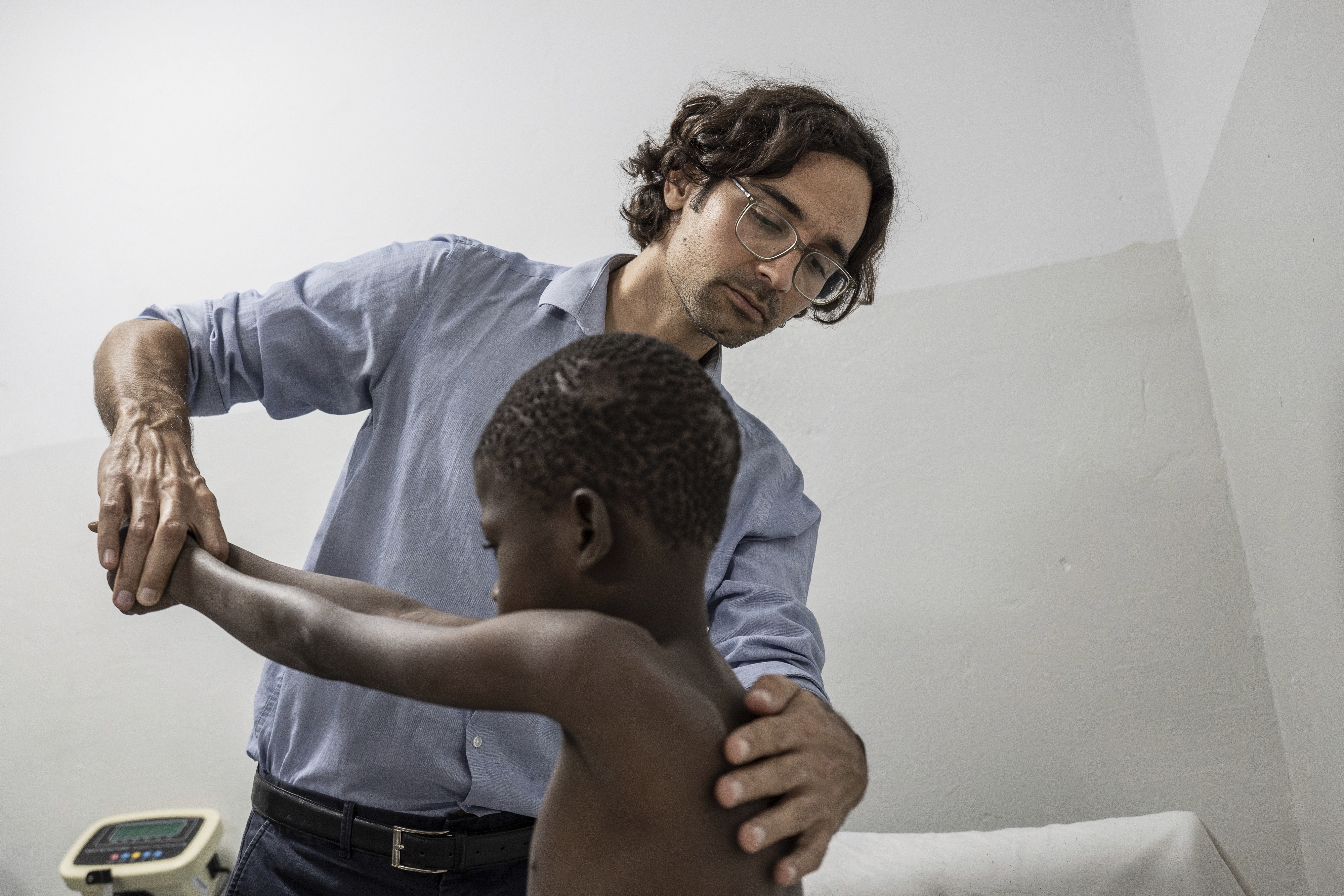 Rare disease researcher Pedro Rodriguez (left) examines Ibrahima Ndiaye, 8, in Dakar, Senegal, Friday, Jan. 10, 2025.<br />(Annika Hammerschlag / AP Photo)