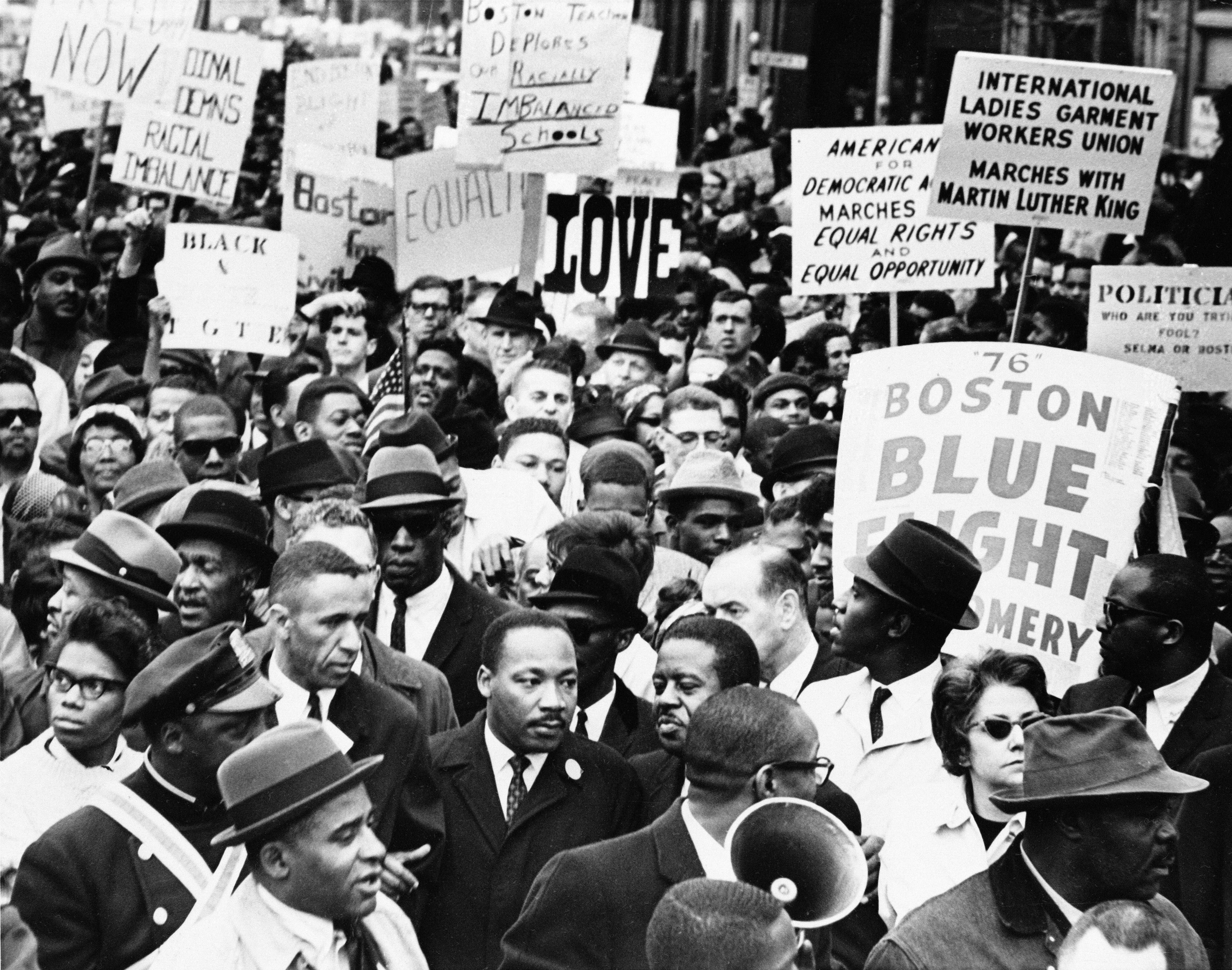 Dr. Martin Luther King Jr., is completely surrounded as he leads a civil rights march in Boston, April 23, 1965, en route to historic Boston Common where he will address a crowd.<br /> (AP Photo)
