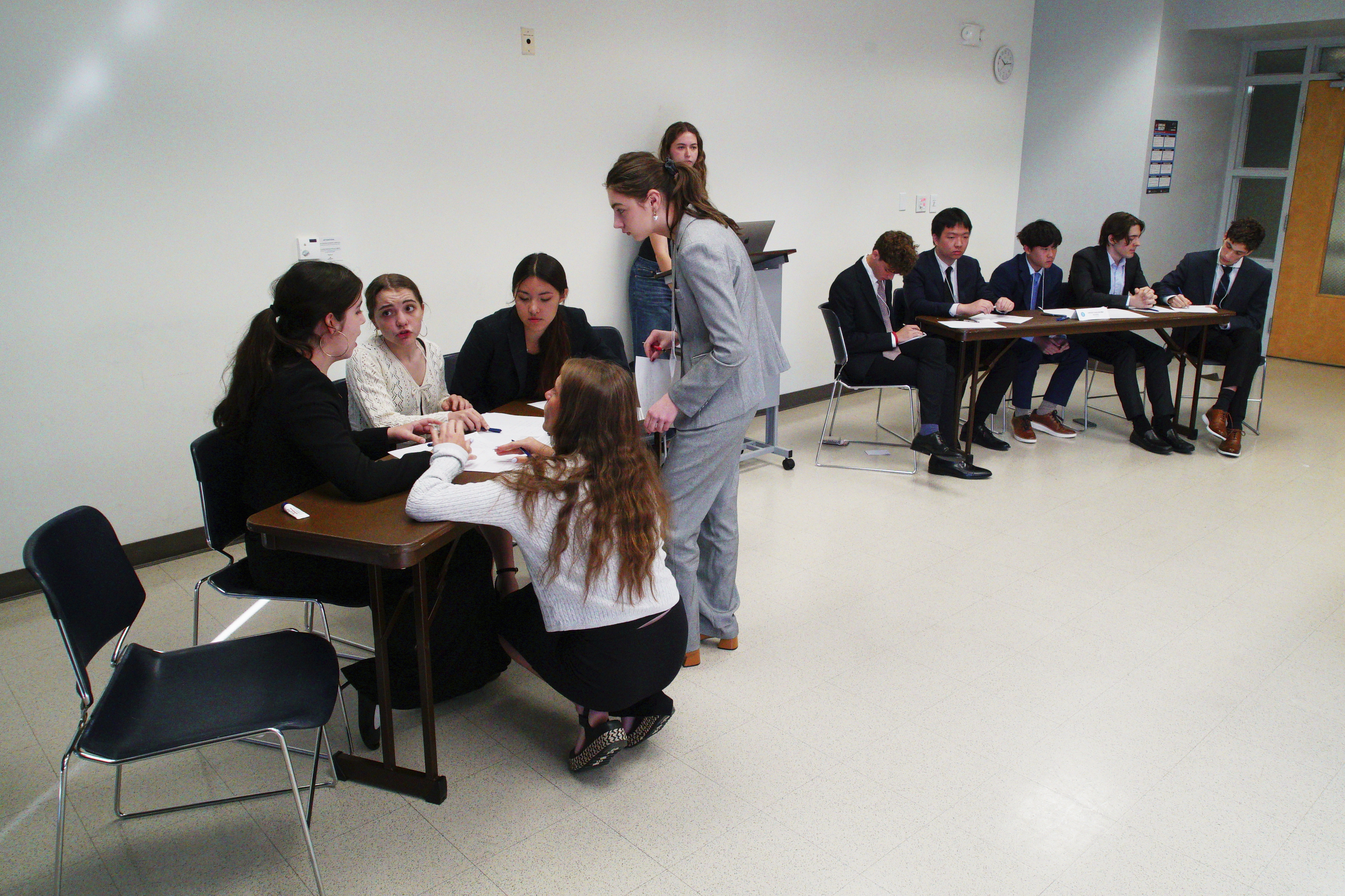 Students from Atlanta&#039;s Midtown High School (foreground) confer during a quarterfinal round at the National High School Ethics Bowl in Chapel Hill, N.C., on Sunday, April 13, 2025.<br /> (Allen G. Breed / AP Photo)