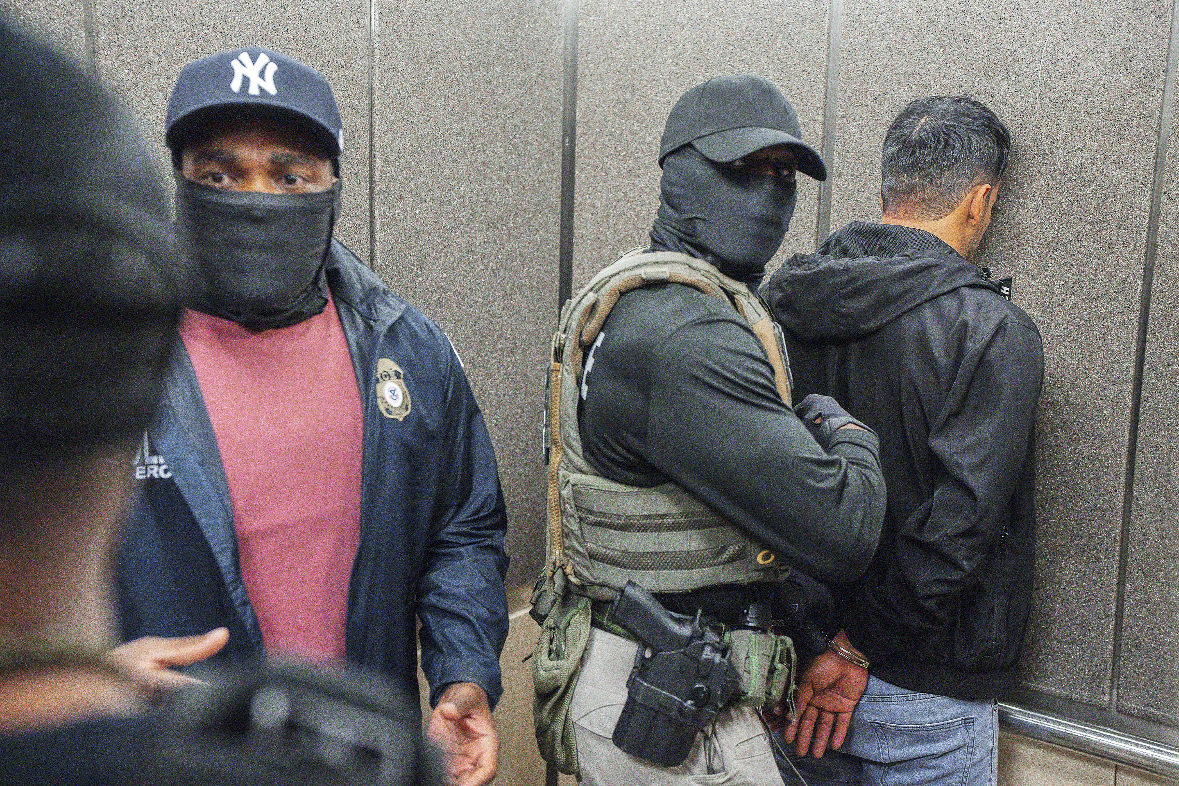 Immigration and Customs Enforcement agents escort a detained immigrant into an elevator after he exited an immigration courtroom, Tuesday, June 17, 2025, in New York.<br />(Olga Fedorova / AP Photo)