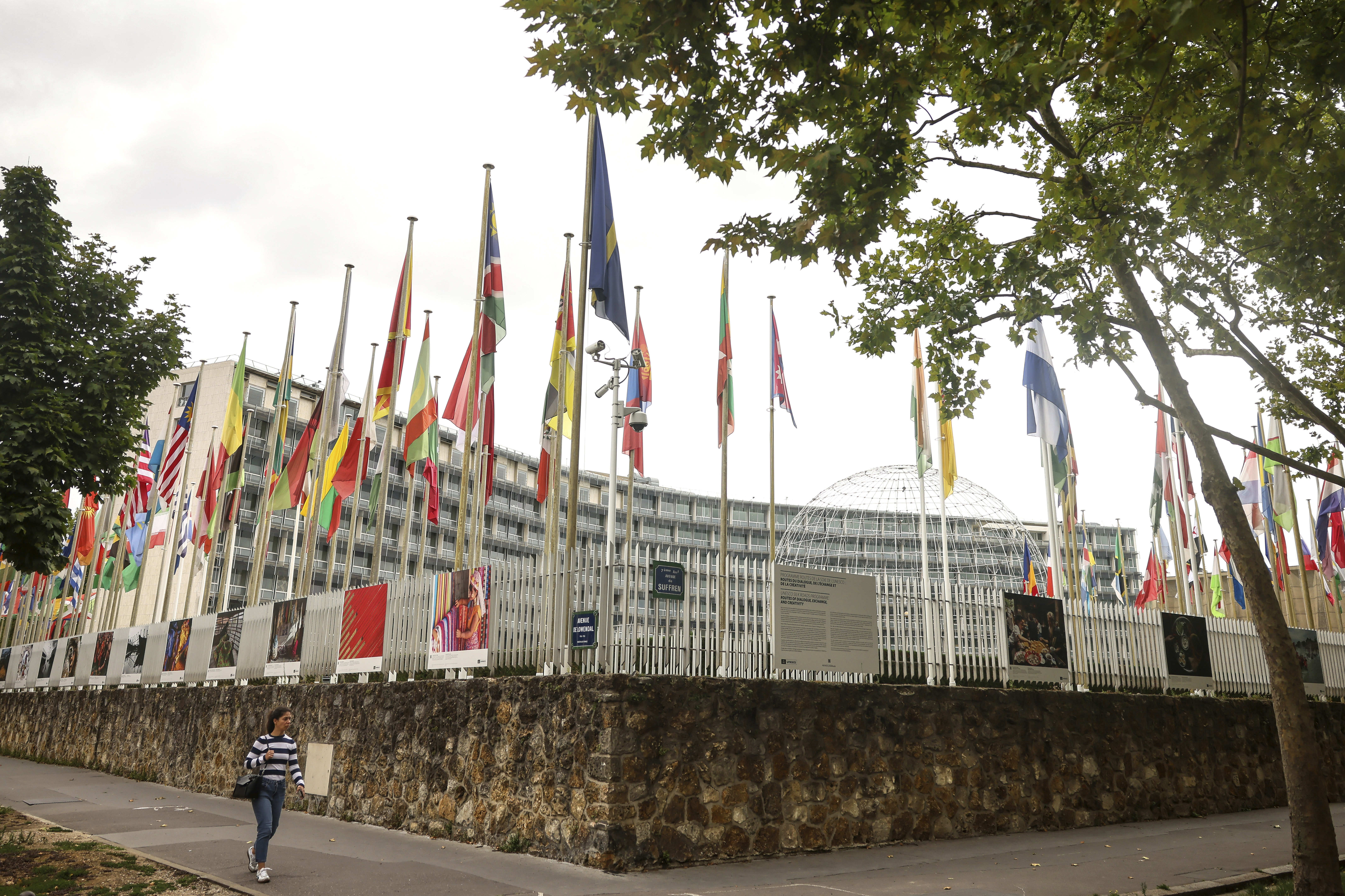 A woman walks by the UNESCO headquarters Tuesday, July 22, 2025 in Paris.<br />(Thomas Padilla / AP Photo)