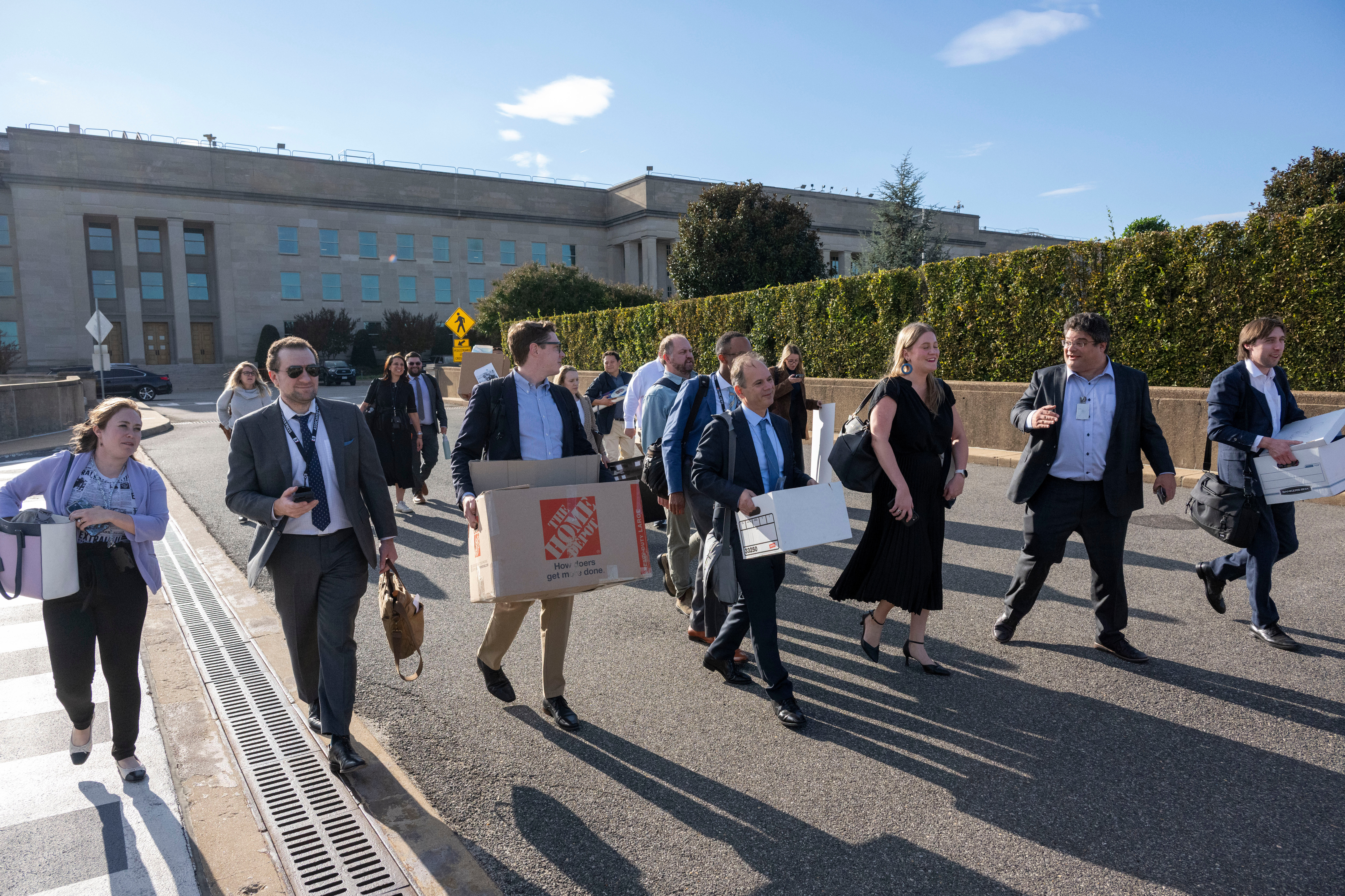 Members of the Pentagon press corp carry their belongings out of the Pentagon after turning in their press credentials, Wednesday, Oct. 15, 2025 in Washington.<br />(Kevin Wolf / AP Photo)