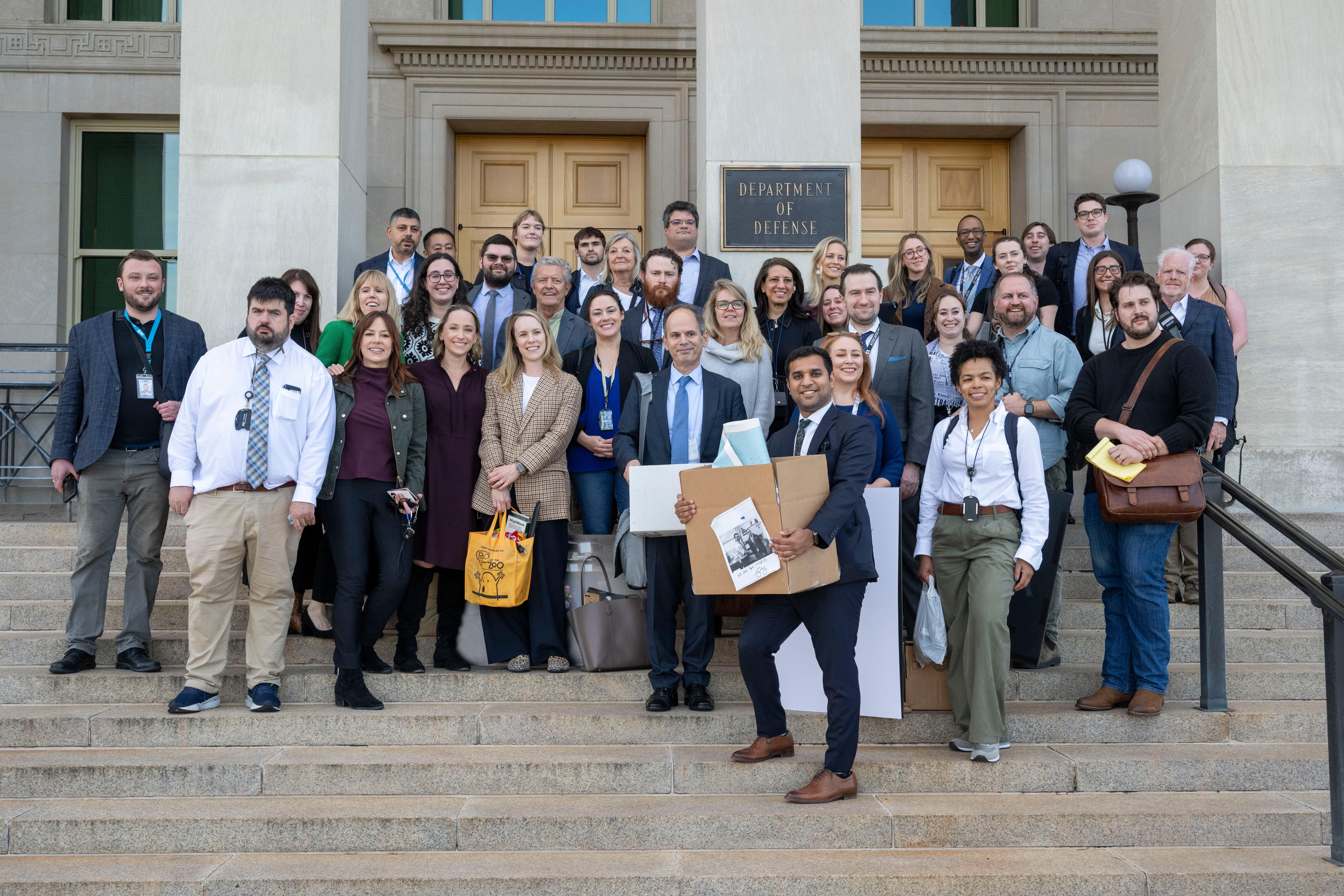 Members of the Pentagon press corp gather for a group photo after turning in their press credentials, Wednesday, Oct. 15, 2025 in Washington.<br />(Kevin Wolf / AP Photo)