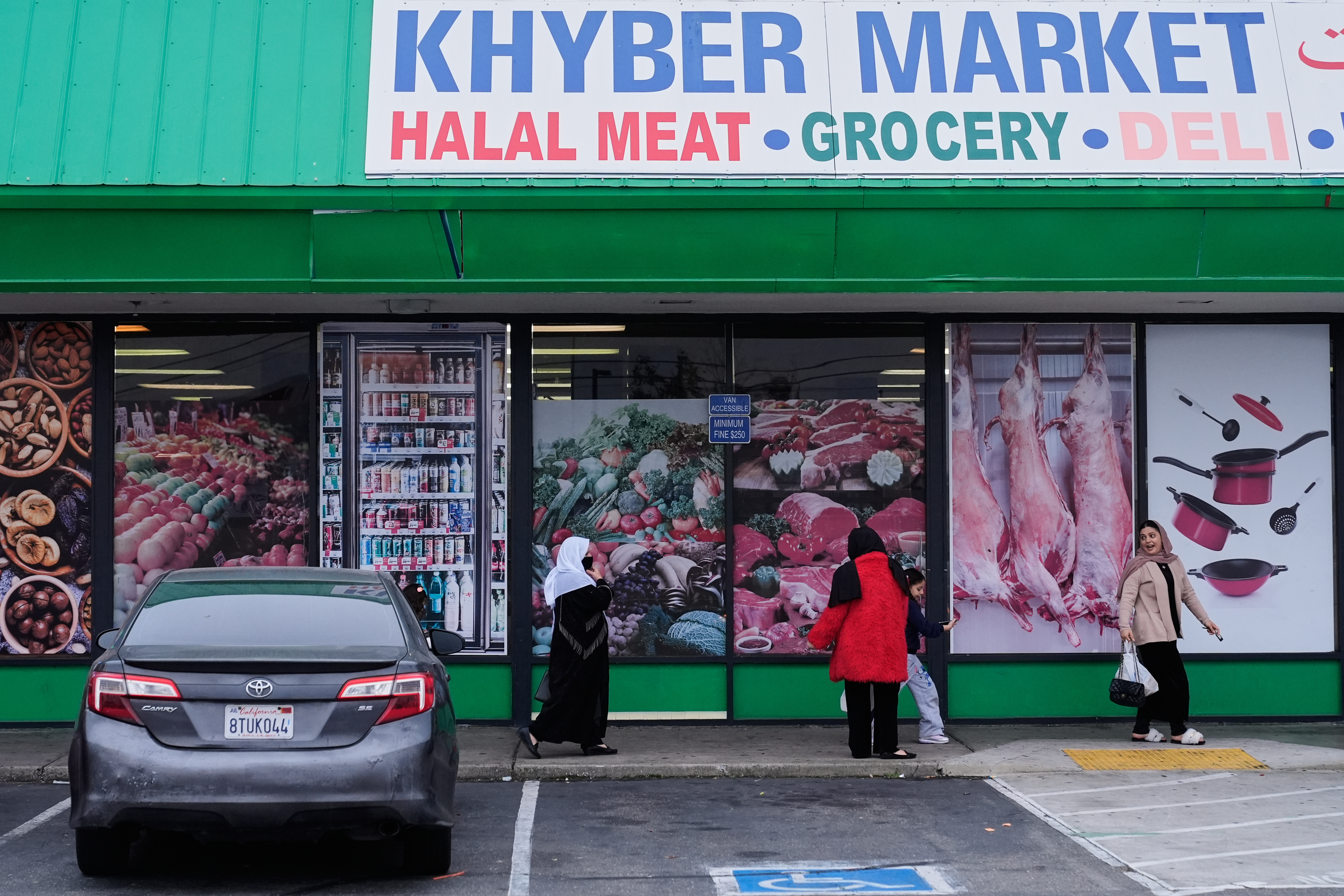 Women and children exit an Afghan grocery store in North Highlands, Calif., Friday, Dec. 5, 2025.<br />(Godofredo A. Vásquez / AP Photo)