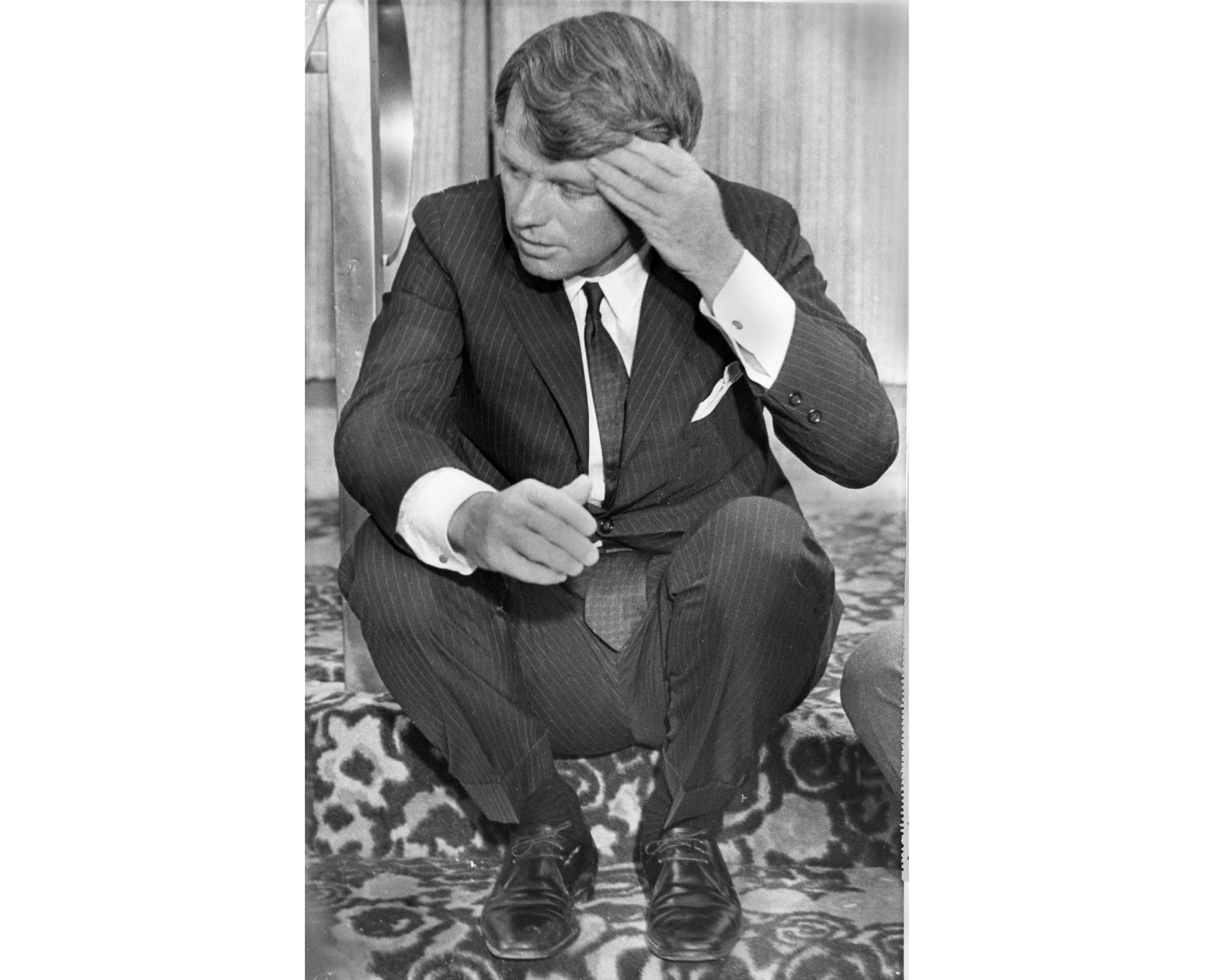 Sen. Robert Kennedy wipes his brow as he catches a few moments of rest on the steps of a downtown hotel in Omaha, Nebraska, May 15, 1968, before one of several press conferences. Kennedy scored a smashing victory in the Nebraska Presidential Primary.<br />(Larry Stoddard / AP Photo)