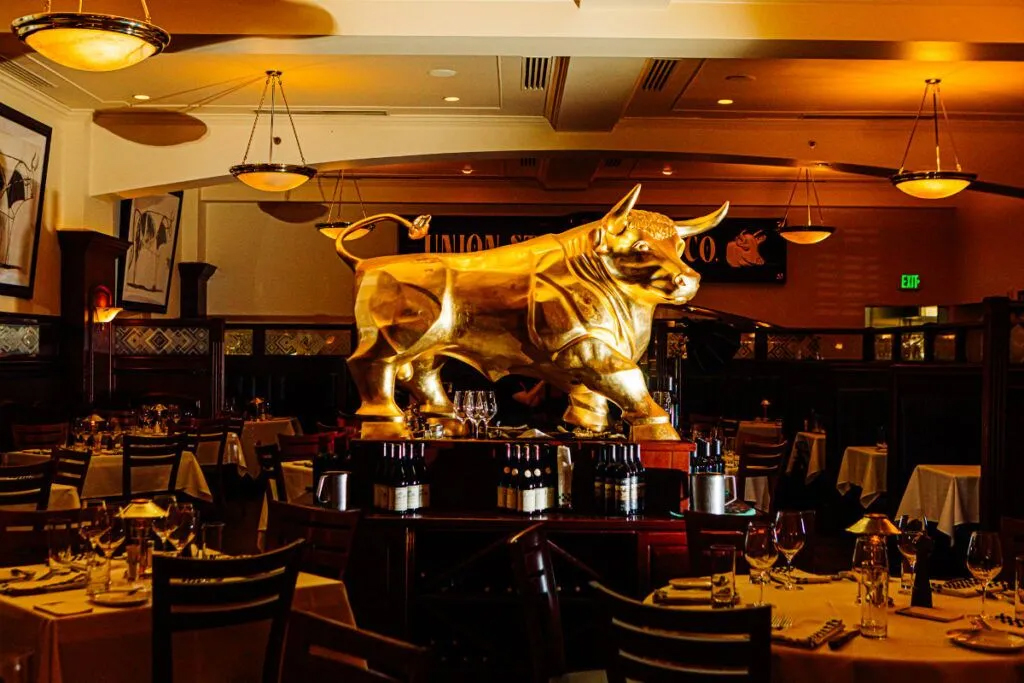 The golden bull sculpture at the center of the dining room is an 801 signature, and each location of the restaurant has one.<br />(Joshua Foo / Flatwater Free Press)