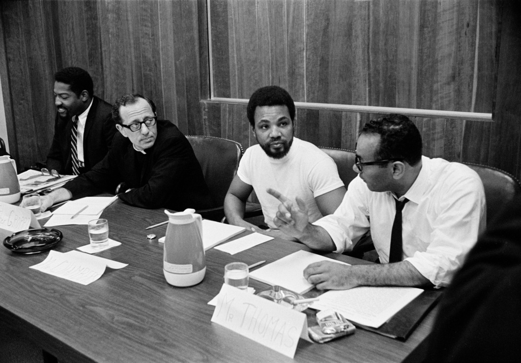 From left: J. Stanley Sanders, Father James Groppi, Ernie Chambers and Piri Thomas exchange views while waiting to testify before the National Advisory Commission on Civil Disorders in Washington on Sept. 21, 1967.<br />(AP Photo)
