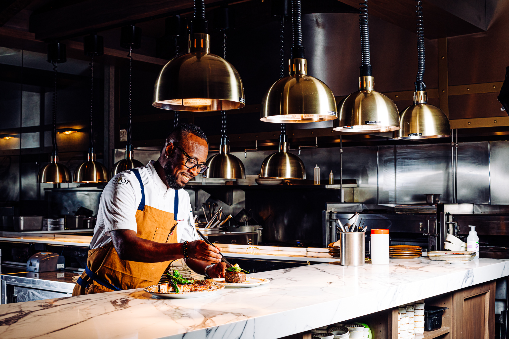 Pivot Prime head chef Joel Hassanali is pictured in Pivot Prime’s open concept kitchen at the restaurant, 13665 California St., which opened earlier this year.<br />(Joshua Foo / Flatwater Free Press)