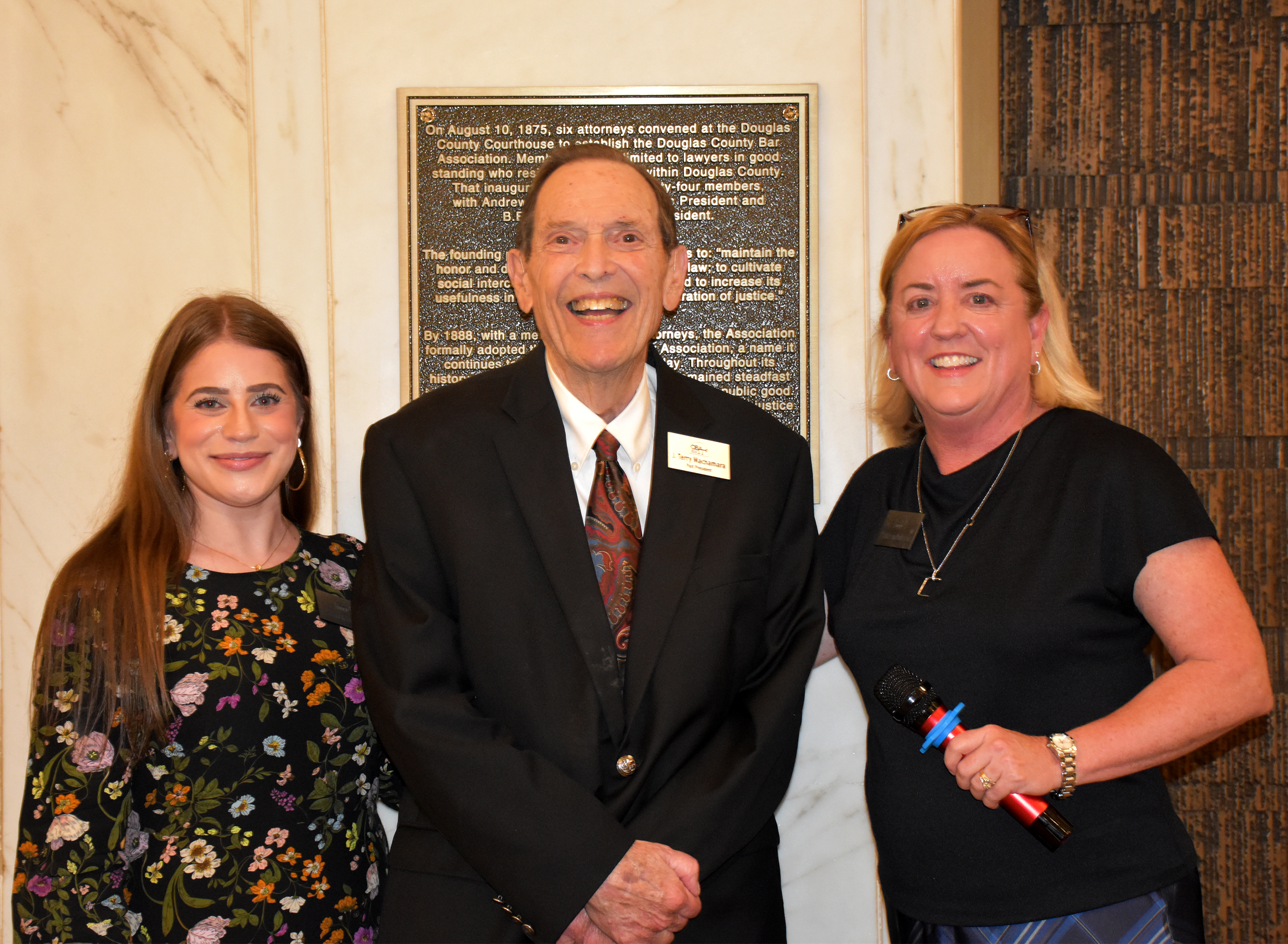 As part of the ceremony, J. Terry Macnamara  (center), past president of the OBA and practitioner for 65 years, and Hannah Frankel (left), in practice for 3 years and current chair of the Young Lawyers Division, were selected to represent the generations of attorneys within the OBA to conduct the unveiling with OBA President Kathleen S. Pallesen (right).<br />(Carla Chance / The Daily Record)
