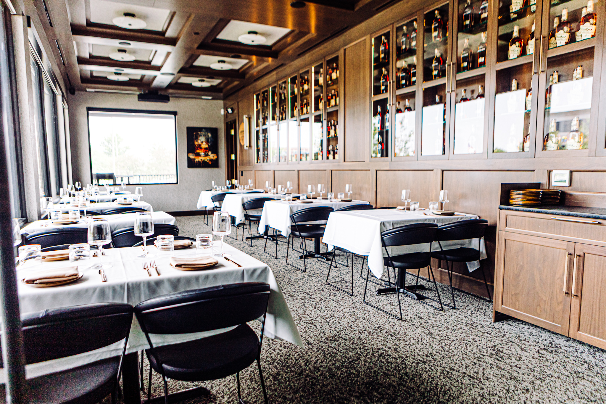 Pivot Prime has several dining areas, all with a similar masculine feel, with wood, rich hues and low lighting.<br />(Joshua Foo / Flatwater Free Press)