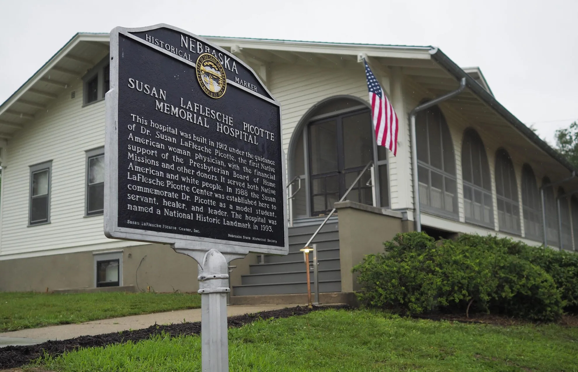 A Nebraska state historical marker acknowledging the former hospital, which will soon reopen as the Dr. Susan La Flesche Picotte Center in Walthill. Dr. Susan La Flesche Picotte was America&#039;s first Native American doctor, who then came back to Nebraska and became the sprawling Omaha Reservation’s first medical doctor. She built this hospital, the first of its kind in America.<br />(Jerry L Mennenga / Flatwater Free Press)