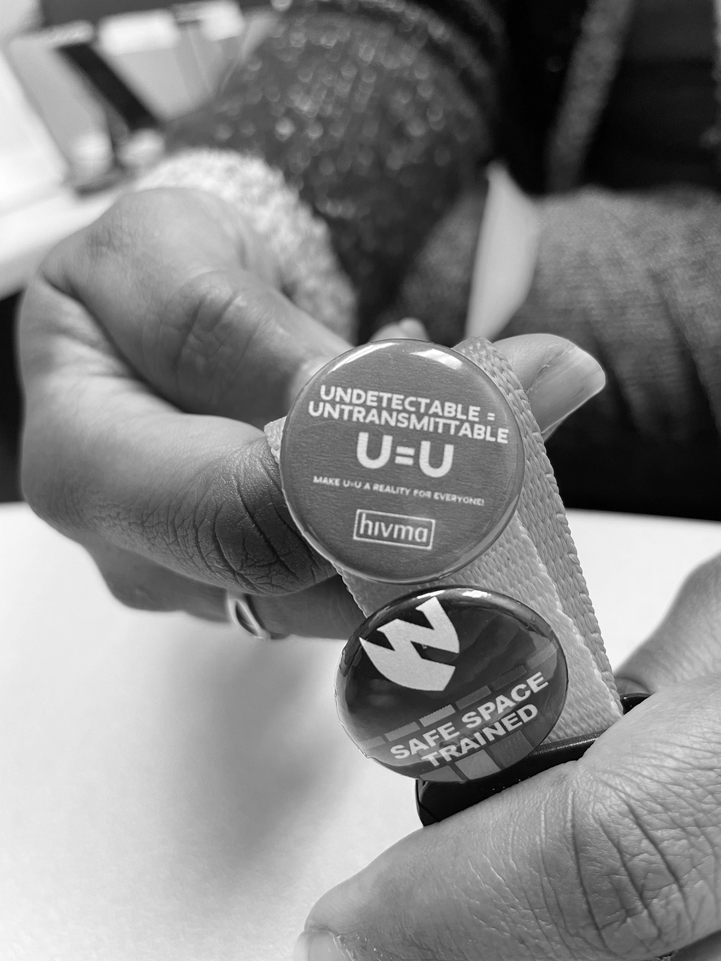 Dr. Nada Fadul holds a U=U button at the University of Nebraska Medical Center’s Specialty Care Center in Omaha. “U Equals U” stands for “undetectable equals untransmittable,” a concept that applies to people with HIV who stick with their treatment and get their viral levels down to basically zero, which means they can’t transmit HIV.<br />(Bob Glissmann / Flatwater Free Press)