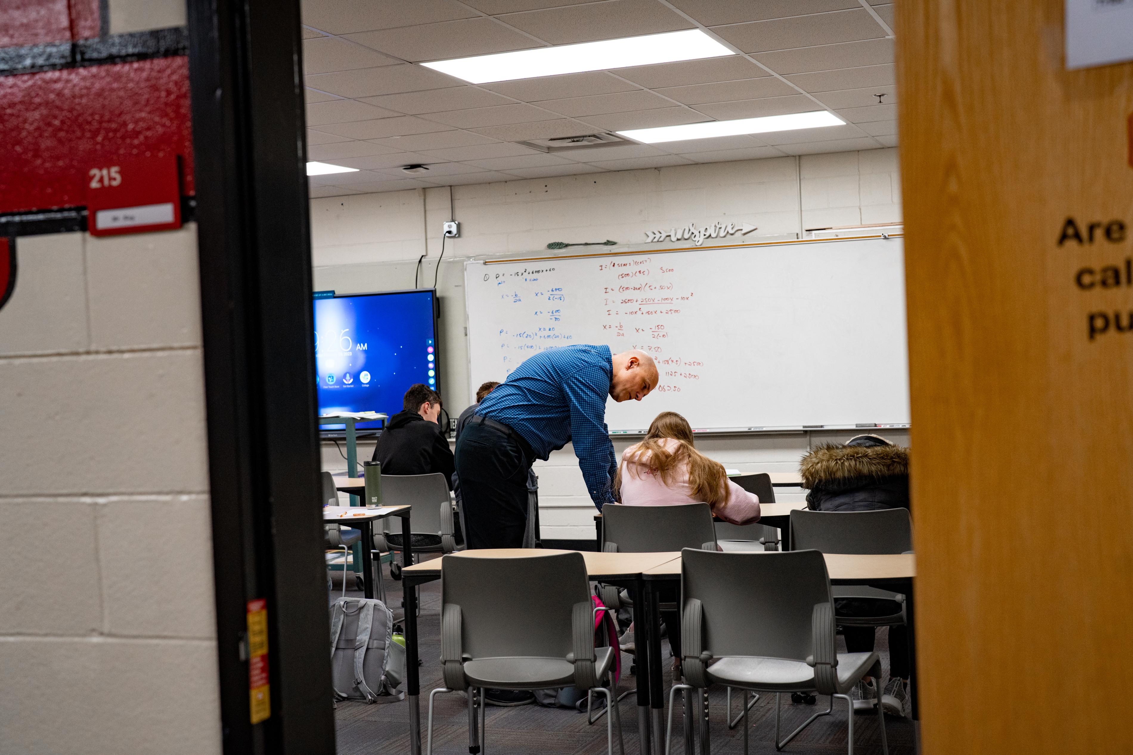 Math teacher David Kay works through an algebra equation with a student in Weeping Water. The school district is one of at least six in Nebraska that have made the switch to a four-day school week. It’s working, say teachers and parents, though some research suggests that it may at least slightly harm student achievement. (Abiola Kosoko / Flatwater Free Press)