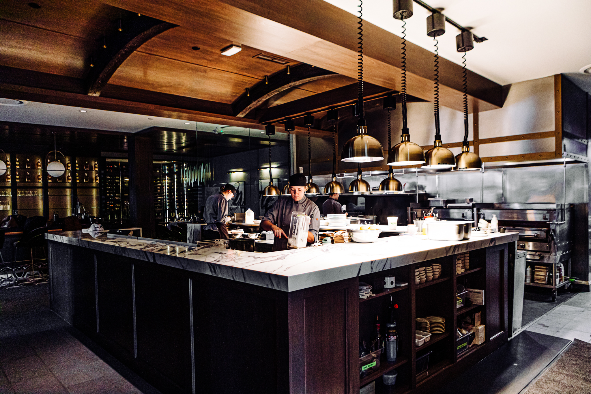 Chefs work in Pivot Prime’s busy open kitchen, adjacent to the bar in the central dining room.<br />(Joshua Foo / Flatwater Free Press)