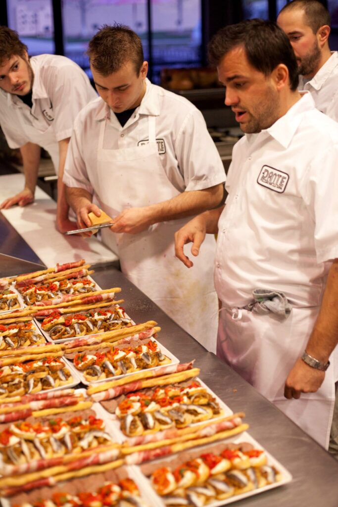 Chef Nick Strawhecker with staff preparing a meal in the kitchen at Dante, 16901 Wright Plaza.<br />(Courtesy photo via Flatwater Free Press)