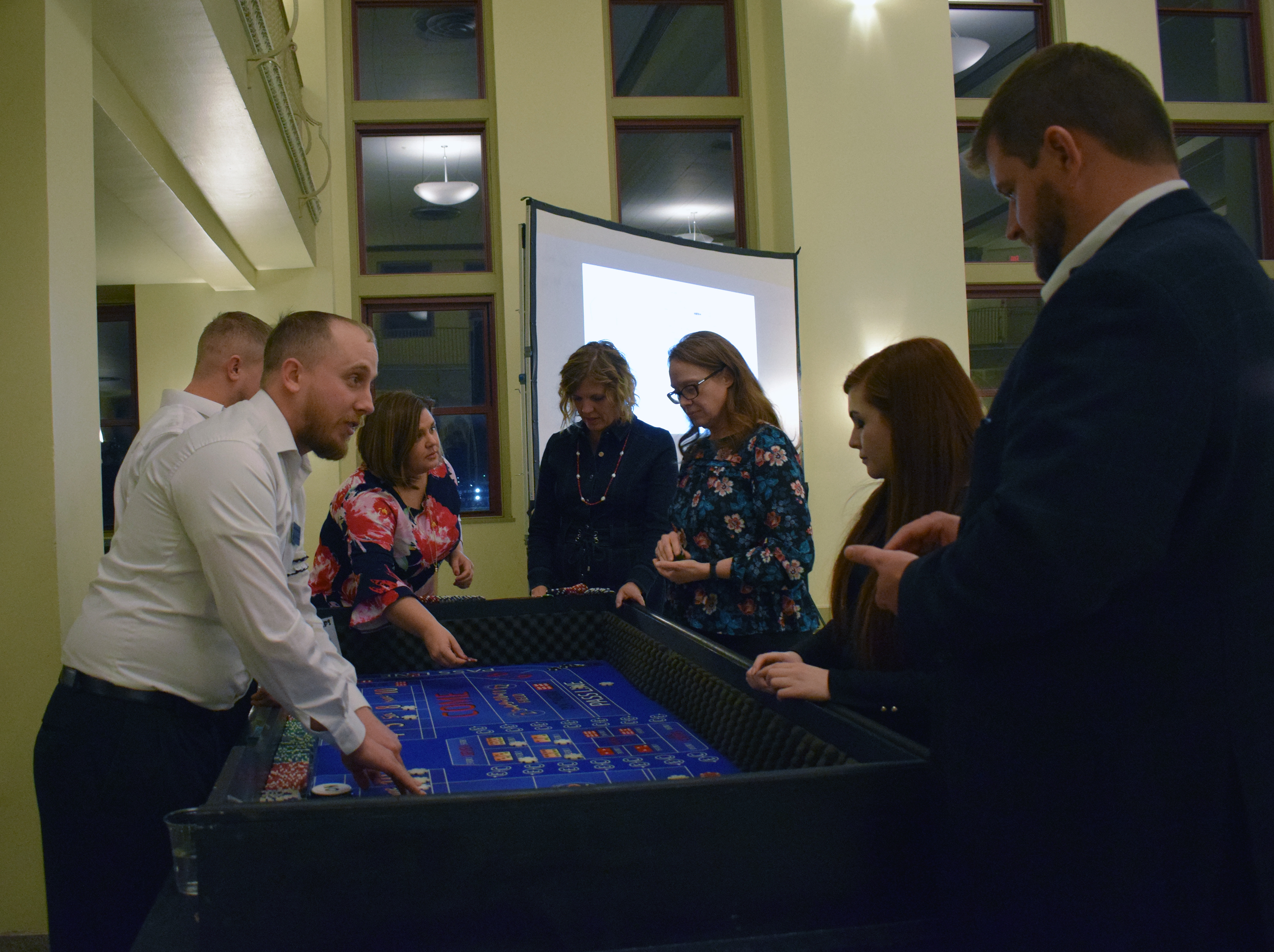 People enjoy a game of craps at the Casino Night at the Omaha Law League Casino Night at the Livestock Exchange Building on March 6, 2020. (Photo by Elizabeth A. Elliott)