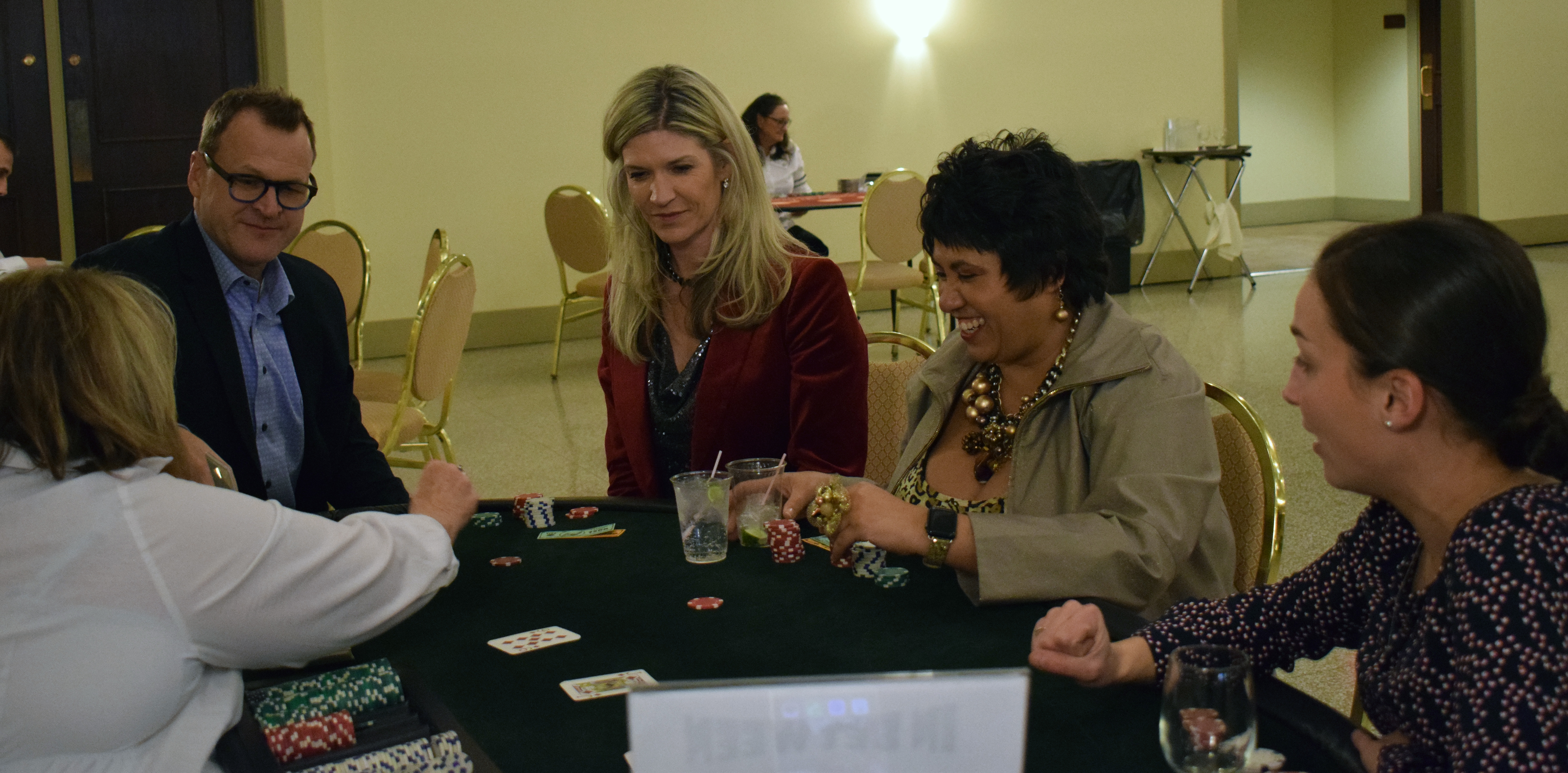 People learn how to play a casino game called In Between at the Omaha Law League Casino Night at the Livestock Exchange Building on March 6, 2020. (Photo by Elizabeth A. Elliott)