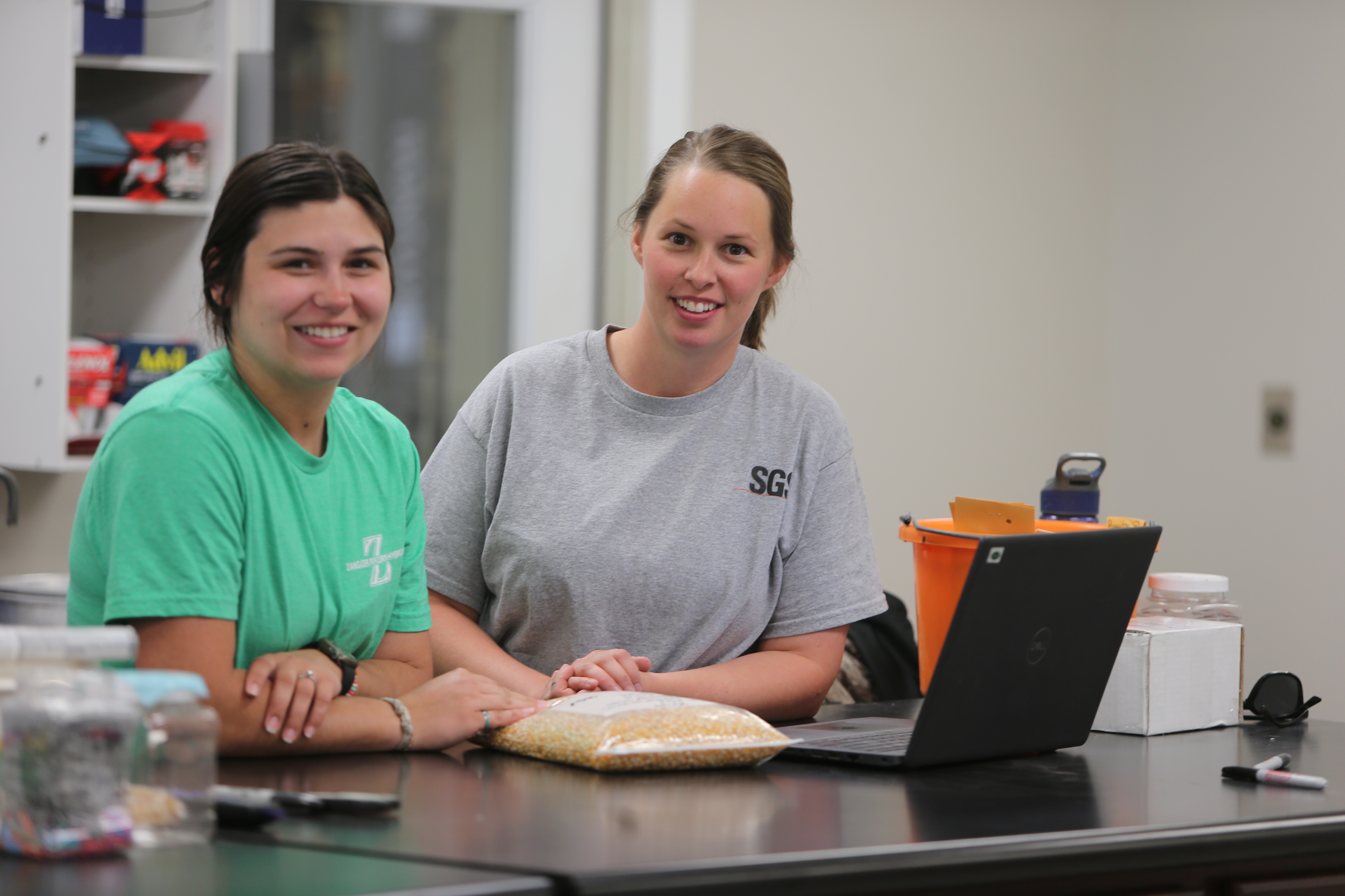 Grace Psota and Justine Gaukel work in the office at Zangger Popcorn Hybrids in North Loup. During its peak season, Zangger employs more than 100 people, making it one of the area’s larger employers.<br />(Troy Brodsky / iNk Photography / Flatwater Free Press)