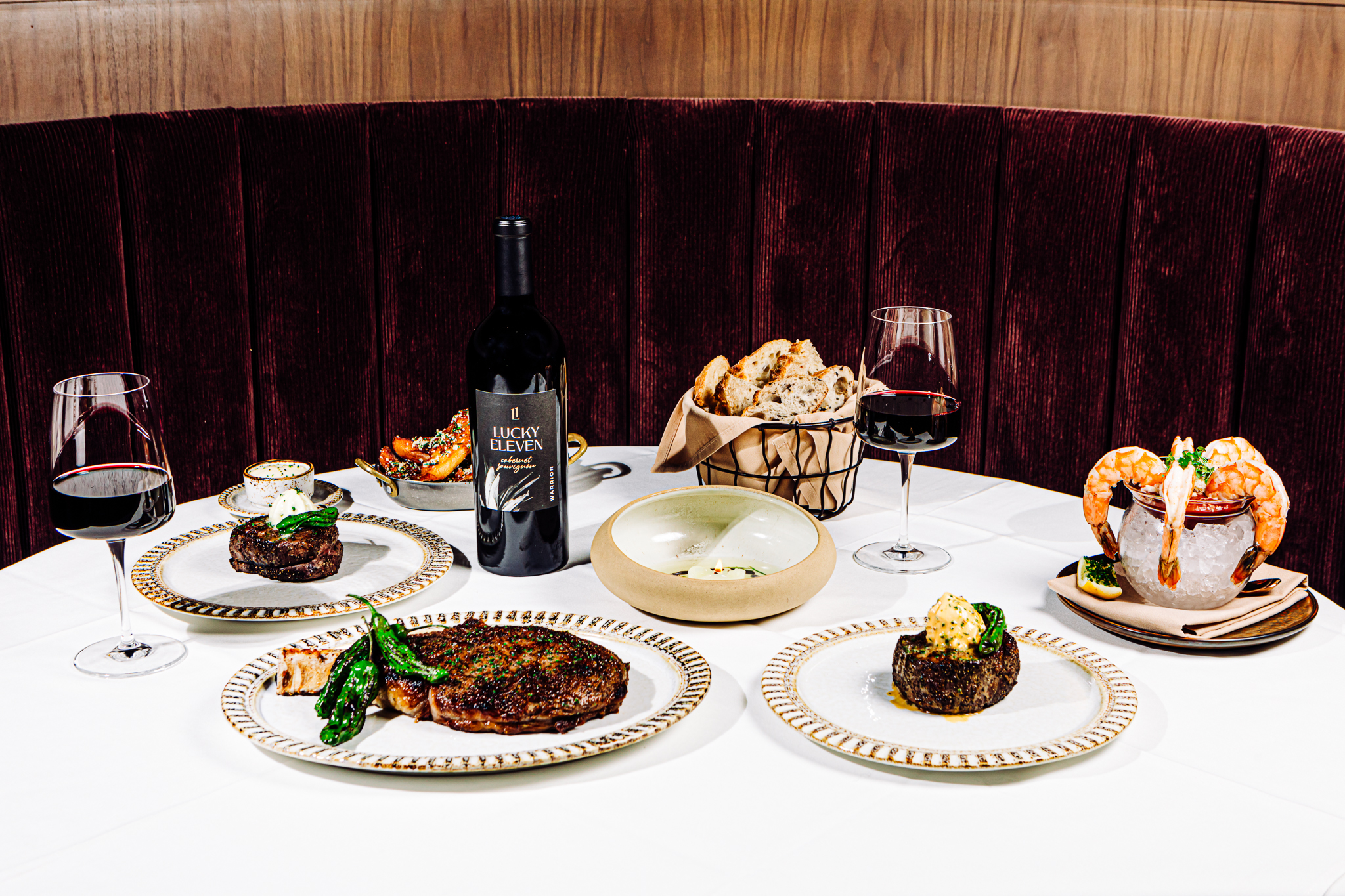 Pictured from left: Manhattan steak, bone-in ribeye, crack fries, Le Quartier bread with the beef tallow candle, filet mignon and shrimp cocktail, all from the menu at west Omaha’s Pivot Prime, which opened earlier this year.<br />(Joshua Foo / Flatwater Free Press)