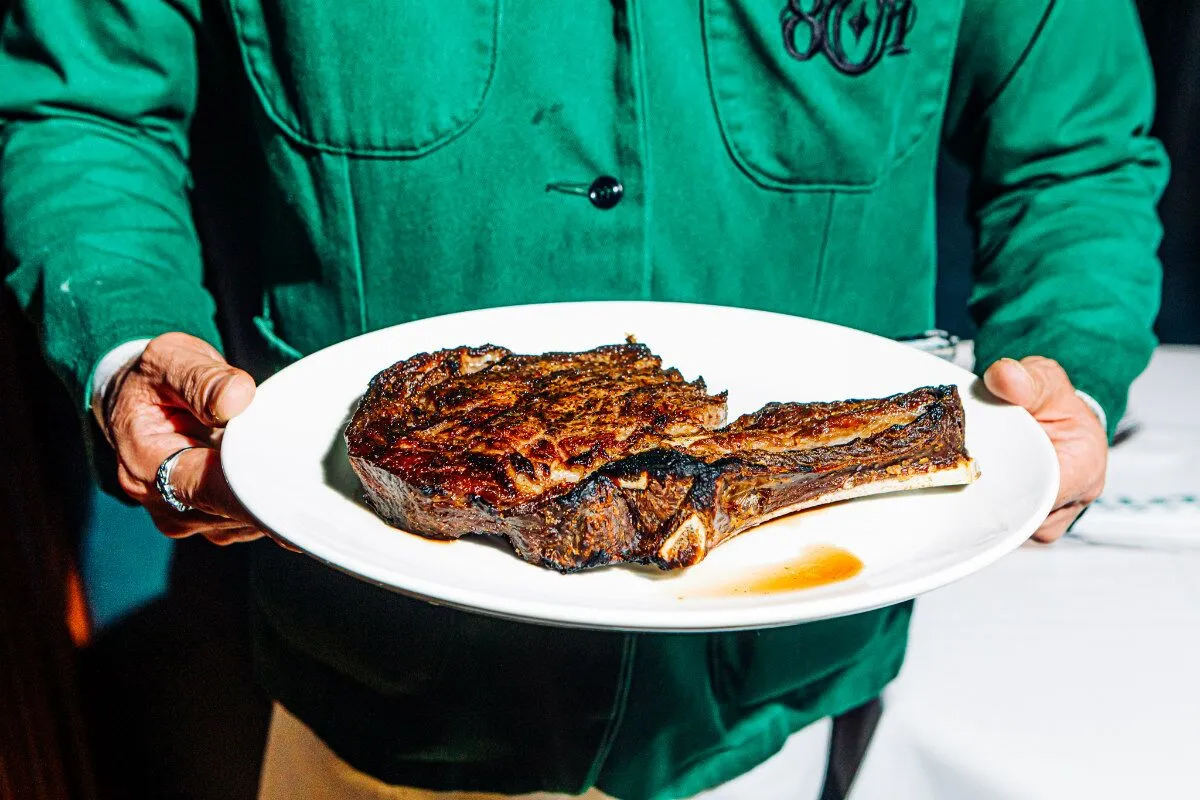 The bone-in ribeye at 801 Chophouse, served to you by a waiter in a crisp green jacket.<br />(Joshua Foo / Flatwater Free Press)