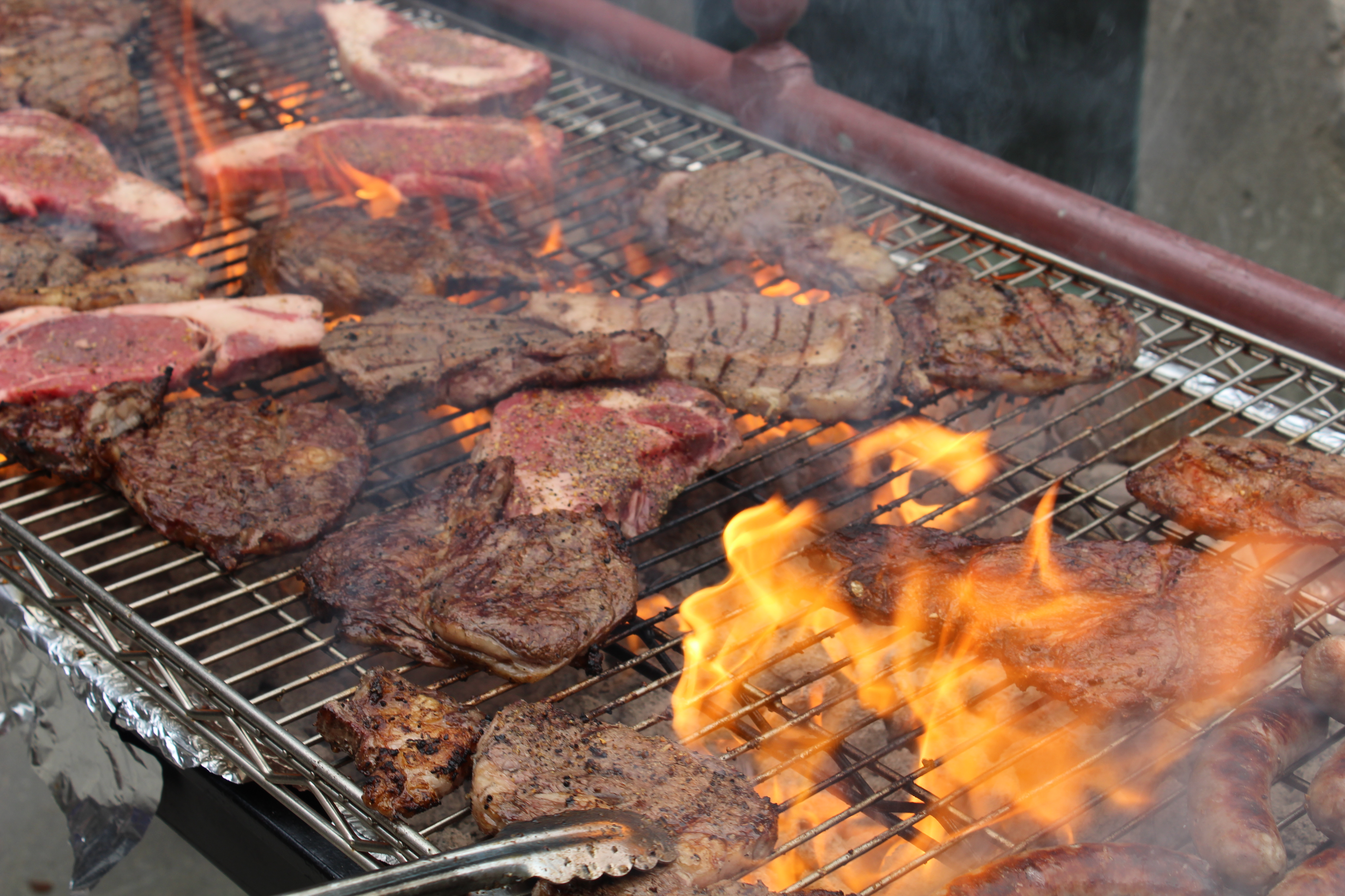 Steaks cook on the grill at Hanscom Park during the Barristers’ Club Steak Fry, Thursday, July 15, 2021. (David Golbitz/Daily Record)