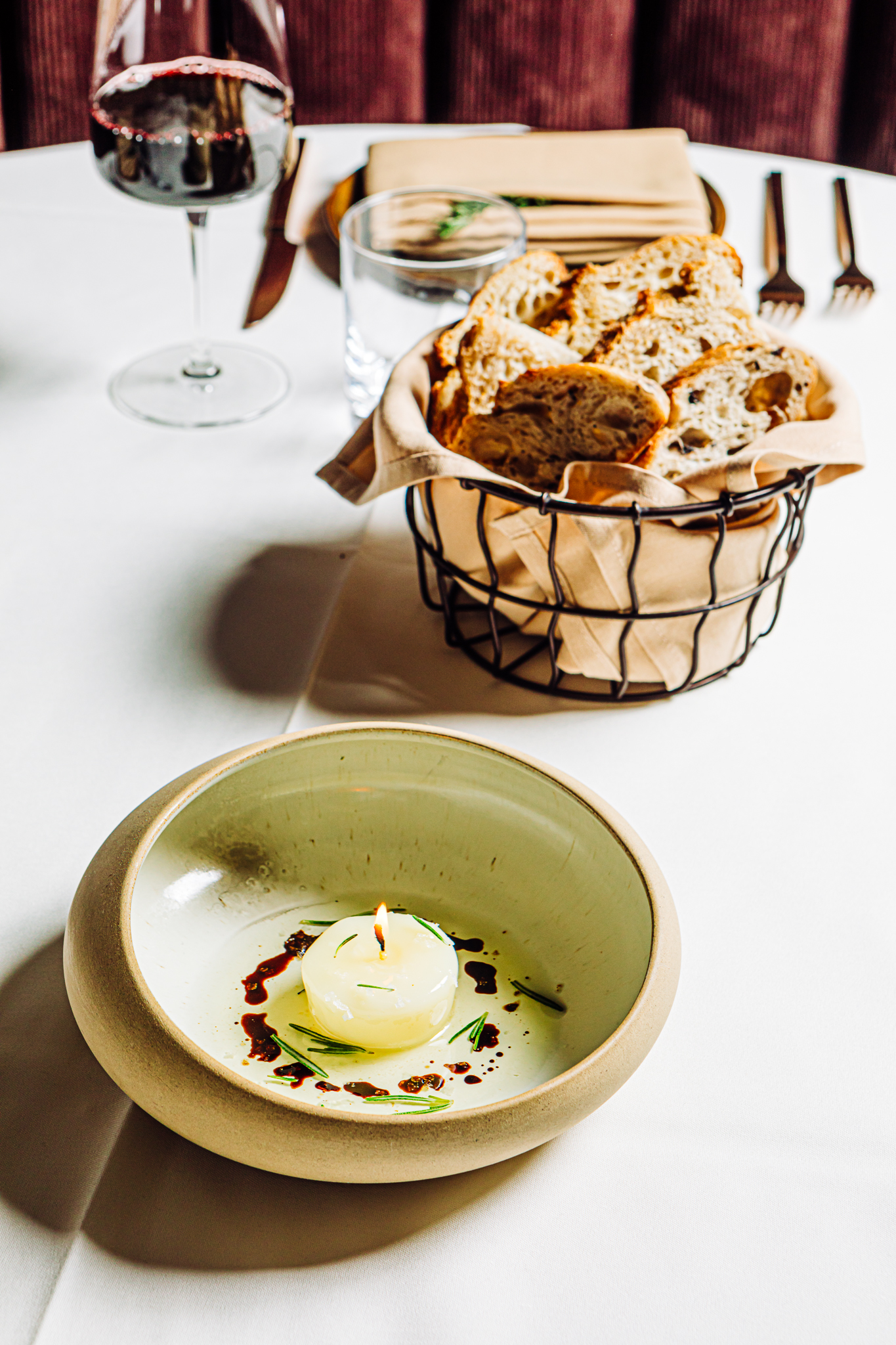 Pivot Prime’s beef tallow candle is flavored with bone marrow, garlic and rosemary, plus aged balsamic vinegar, and served with a side of locally baked bread.<br />(Joshua Foo / Flatwater Free Press)