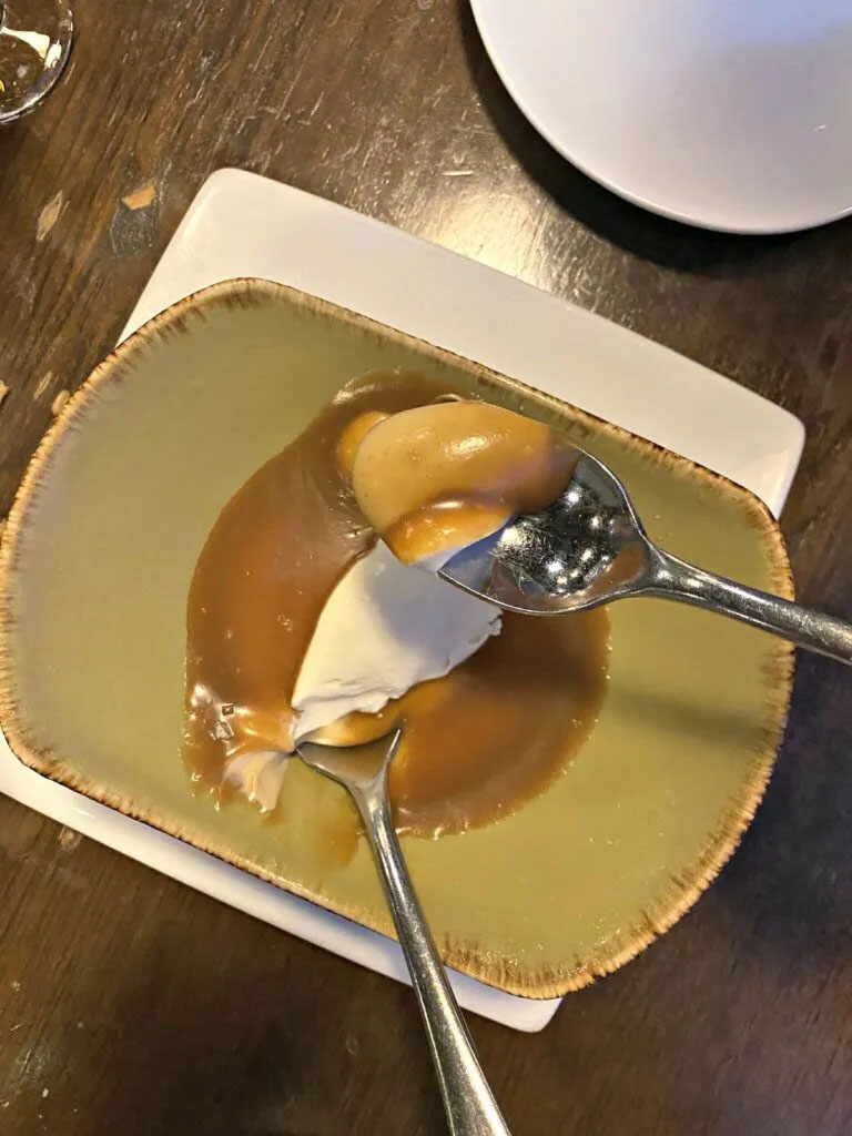Butterscotch budino, a classic Italian custard dessert, gets topped with salted caramel and flaky salt.<br />(Sarah Baker Hansen / Flatwater Free Press)